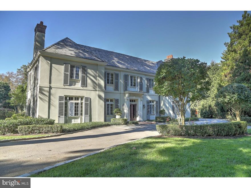 Nestled on a breathtaking acre of property, this spectacular 3-story estate home enjoys a superior location in Northside Bryn Mawr, with access to all conveniences & award-winning Lower Merion Schools. Also located on the pristine grounds with lush lawn, perennial gardens, specimen plantings, landscape lighting, and new fencing & gates is a beautiful swimming pool for resort-style living. Generous parking is provided in the spacious drive and detached 3-car garage with new doors & a renovated, open concept studio apartment with a kitchenette above it. This classic Colonial has been lovingly restored, thoughtfully expanded & meticulously appointed by its discerning owners, with approximately a half a million dollars in improvements made since 2013. Elegant details & old world character set forth by beamed ceilings, custom built-ins & arched doorways are complemented by the modern amenities & desirable floorplan desired by today's upscale buyers. Extensive upgrades include conversion to a gas furnace with upgraded HVAC, state-of-the-art security, new speakers in main rooms & on the new pool deck, a high-end remotely-controlled AV system & other smart features. Entertain in style in the grand living room that spills into the formal dining room, both with hardwood floors, gorgeous millwork & fireplaces. A wood-paneled den/library with a fireplace & built-in bookshelves is an intimate setting for cocktails or reading. The huge gourmet kitchen is a chef's delight & central gathering spot graced by Signature custom cabinetry, granite counters & island, rich hardwood floors & top-grade stainless steel appliances. Adjacent sits the family room keeping everyone comfortable & connected, with ceiling beams, custom built-ins & a cozy fireplace. An architecturally distinctive wood staircase with a graceful iron railing winds up to the 2nd level where you'll find your stunning master suite. Sunny exposures, a fireplace, fitted walk-in closet & a spa-inspired marble bathroom indulge your senses. The baths in the home including the 1st-floor powder room have been nicely updated. The 2nd floor also presents 3 large light-filled BRs, 3 full baths & a study/home office. Perched on the 3rd story is a bonus/rec room, BR with built-ins & full bath with sky-lit shower. An unfinished basement with laundry and a climate-controlled wine cellar are other highlights of this magnificent, ideally-addressed residence.