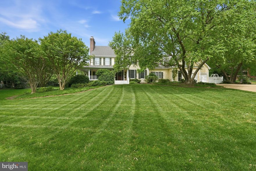 2120 Elliott Avenue is one of Franklin Park's most recognizable homes—an iconic yellow farmhouse set on over an acre of sweeping, tree-framed grounds. Introduced by a broad, manicured lawn and anchored by mature trees, the home presents with a sense of permanence and quiet distinction rarely found.
Its authentic wrap-around porch and classic proportions define a silhouette that is both familiar and timeless—capturing the essence of a true American farmhouse. The soft yellow façade, articulated with traditional detailing and balanced fenestration, reinforces the home’s warmth and approachability, while four fireplaces within speak to its history of gathering and lived-in elegance.  Renovations have been done over the recent years including the kitchen, all baths, lighting, furniture-grade built-ins and beautiful hand-scraped walnut hardwood flooring.

A gracious front approach leads to interiors that unfold with ease and authenticity. The foyer opens to a handsome library, setting a tone of understated refinement. Formal living and dining rooms flow naturally, offering a sense of proportion and continuity suited to both everyday living and entertaining. At the center of the home, a thoughtfully renovated kitchen integrates modern function with classic design, opening to the gracious family room and a lovely covered rear porch for a seamless indoor-outdoor connection.

The family room provides a relaxed, inviting counterpart to the more formal spaces, while a main-level bedroom suite—with full bath and private entrance and wetbar—offers exceptional flexibility for guests, multigenerational living, or a functional home office. A large mudroom and family powder room connects efficiently to the attached garage, reinforcing the home’s practical livability.

Upstairs, five bedrooms are well-scaled and thoughtfully arranged. The primary suite, recently updated, serves as a quiet retreat, while four additional bedrooms provide flexibility and comfort, supported by well-appointed baths and a large laundry room. The rear staircase leads to a landing with a fantastic upstairs family or playroom.  Character details such as window seats and sconces add to the charm.

The lower level extends the home’s functionality with recreation, fitness, additional bedroom and bath accommodations, a new beverage center, and direct access to the grounds—creating a seamless extension of the living space.

Outdoors, the property unfolds with a natural rhythm—expansive lawn, mature canopy, and curated outdoor living anchored by a private patio with fireplace and built-in grille. The setting feels both open and protected, offering a rare balance of space, privacy, and connection to nature.

2120 Elliott Avenue stands as a true landmark offering—defined by authenticity, architectural character, and an irreplaceable setting within one of McLean’s most established and admired