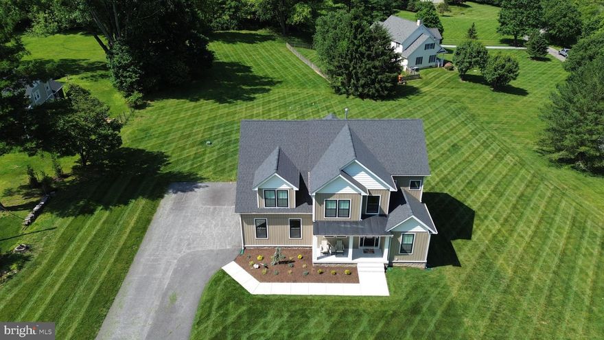 Pristine custom home nestled  on 1+ acre homesite in sought out Monkton community.  Built in 2022, this exquisite Colonial-style residence boasts 4,142 Fin sq. ft. of thoughtfully designed living space, perfect for modern lifestyles. Step inside to find an inviting open floor plan  boasting gourmet kitchen w/ oversized island, and huge walk-in pantry!  Dining & Family-Great room perfect for hosting gatherings or enjoying a cozy evening by the  stone gas fireplace. The main level also features a convenient mudroom with custom built-in cubbies, spacious light-filled office and guest bath. The luxurious primary suite with large walk-in closet and oversized walk-in shower offers ample space for relaxation and privacy. 2nd Floor also boasts  convenient 2nd floor laundry plus 3 additional bedrooms and 2 more full baths.  The fully finished walkout basement provides additional living space, ideal for a rec room, home theater, play area and/or guest bedroom suite. Outside, the property sits on a beautifully cleared 1.1-acre lot that backs to tranquil trees, offering a peaceful retreat. Enjoy outdoor living on the porch or deck, perfect for morning coffee or evening gatherings. The side-entry  garage  features bonus shop area and oversized paved driveway providing plenty of parking for guests. Experience the perfect blend of comfort and elegance in this exceptional home, where every detail has been crafted for your enjoyment.  NO HOA & Convenient walk to NCR Trail plus all the amenities of  HuntValley & easy access to 83 & more !  Don’t miss the opportunity to make this your dream home!