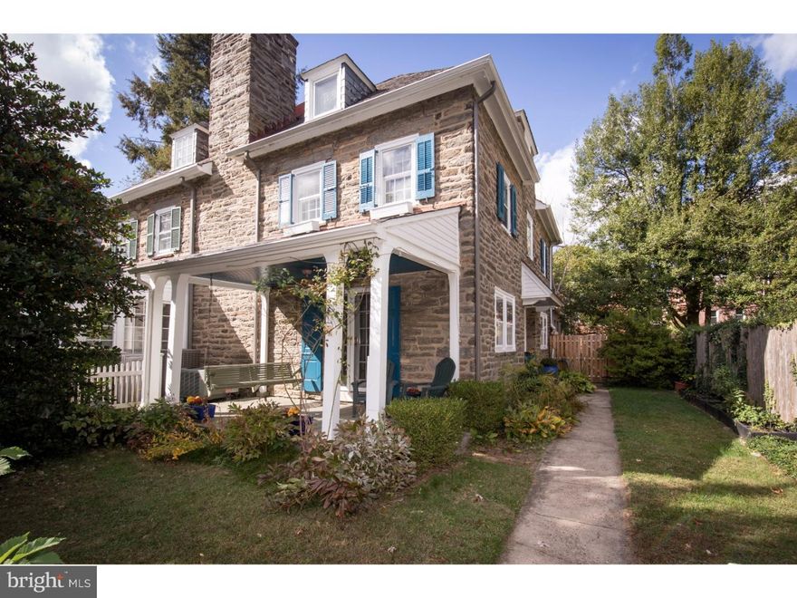 Gracious Chestnut Hill stone twin designed by Robert McGoodwin. Enter the home into the large entry hall. Living room with wood burning fireplace with brick surround, built in bookcases and french doors that lead to the charming front covered porch with porch swing. Dining room with crown molding and corner shelving that opens to the wet bar and bright updated kitchen with stainless steel appliances, exposed brick wall and breakfast room addition with extra cabinets for storage, counter space and exposed stone wall. The powder room off the entry hall completes the first floor. The second floor includes three bedrooms with excellent closet space, built in bookcases and a hall bath. The third floor includes two additional bedrooms and a recently updated hall bathroom with double sink vanity and restored original claw foot tub. Refinished hardwood floors, deep window sills, high ceilings, period moldings and slate roof. Updated systems include central air conditioning, new water heater and newer HVAC system. The grounds are professionally landscaped with mature specimen trees and perennials. Private, fully fenced backyard with charming brick patios perfect for relaxing and entertaining. Be in the heart of Chestnut Hill and walk to all the shops, restaurants, trains and Fairmount Park. Welcome home!