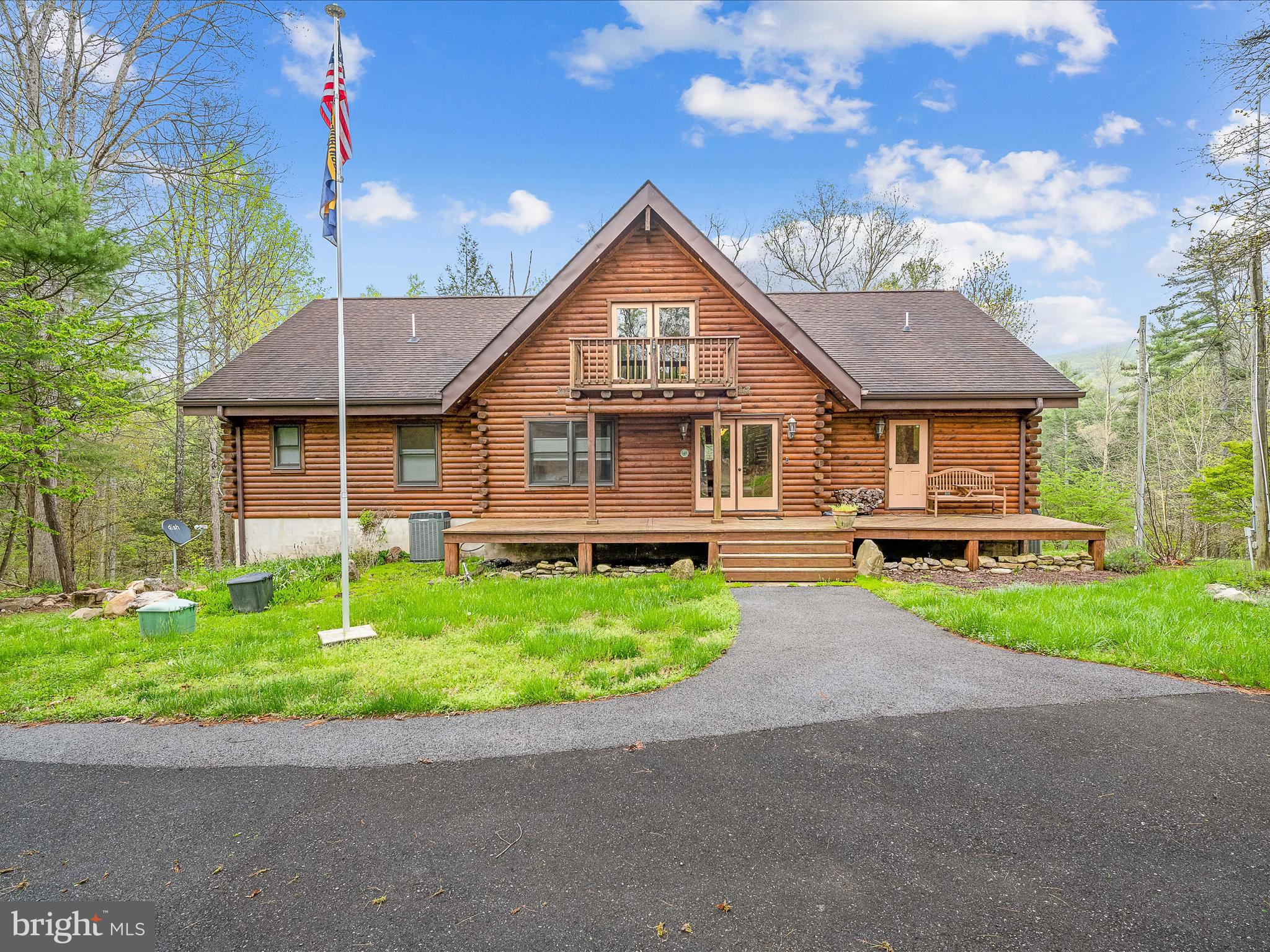 Stunning Log Home in the mountains of West Virginia - Large open floor plan with 2 stone fireplaces, exposed beamed ceilings with pine planking, beautiful hardwood floors through out. From your deck you'll enjoy listening to the ripples from the small creek (Meadow Branch) below. Fully appointed kitchen with island bar and granite counter tops, large dining room, 2 main level bedrooms, and 2.5 Bathrooms. Open staircase to the loft. Lower level has large fully completed Kitchen and Bath, the other rooms are nearly completed, this would make an excellent Mother In Law suite or rental. Also Generac, whole house generator is installed so you don't have to worry about losing electricity. Brand New 30 x 40 garage, with electric and concrete floor. Enjoy private access to the Sleepy Creek WMA nearby for the outdoor lover with over 22,000 acres waiting to be explored. Convenient to Martinsburg/I-81 and only 9 miles to downtown Berkeley Springs.