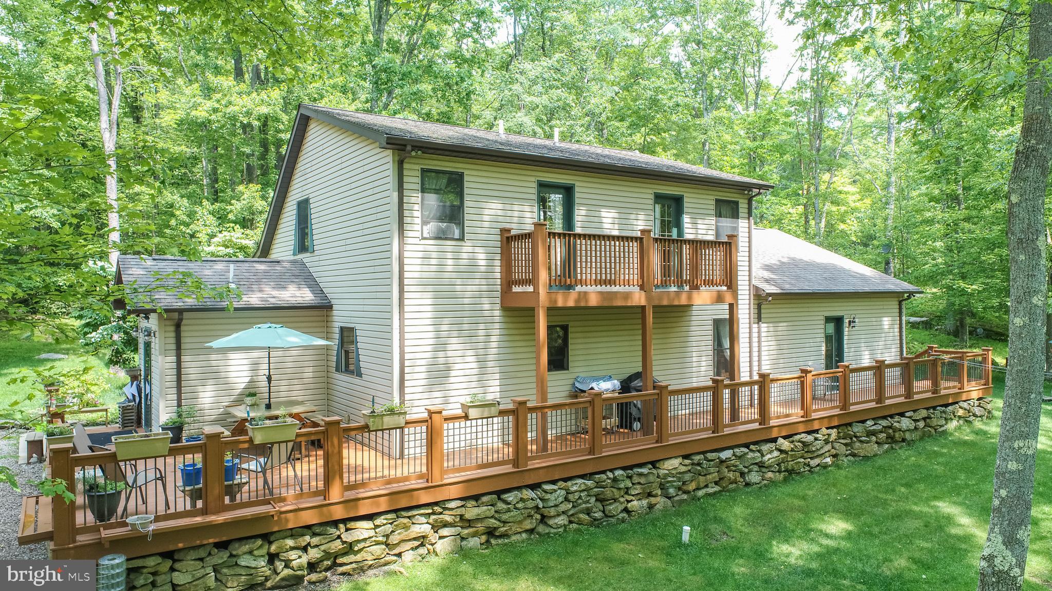 Designed and built for the sellers, this 4 bedroom, 2.5 bath home is a true showcase of craftsmanship featuring handmade woodwork crafted from trees sourced directly from the property. Many specialty items will remain, including bathroom vanities, multiple dressers, a primary suite custom TV console, a built-in bunk bed, and more. The spacious primary suite was added in 2016 and offers a separate living area, cozy gas fireplace, and beautiful hardwood floors. The open floor plan on the main living level with kitchen and dining areas is perfect for family gatherings and entertaining guests. The entry-level laundry with dog wash, a screened porch, and separate office space check all the boxes for your "wish list".
Enjoy your outside space with a little over 3 acres, complete with a firepit area and walking trails throughout the property. Two detached garages, one oversized and both finished, are insulated for cars, additional storage, or hobby workshop. The A-frame cottage for kids is perfect for the ultimate in playtime
Make an appointment today to tour this one-of-a-kind home in this beautiful "park-like" setting! Special Financing Options Available.