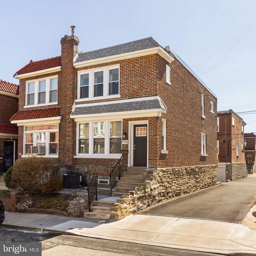 Introducing 1994 Penfield Street! This recently renovated home situated on a corner lot impresses immediately with its immaculate brick construction, original and refinished parquet hardwood flooring, and additional windows which bring natural light into the heart of the home.  Fully permitted renovation last year by reputable builder with all new electrical, framing, and upgrade to central HVAC. Enter to an open main level with oversized living and dining area. Fireplace at the heart of the home. Modern kitchen installed only one year ago feature quartz countertops, white shaker cabinets, and stainless appliances. Elevated rear deck adds additional space to the already spacious main level! At the stairs, notice the preserved, cast-iron railing and the additional window at the top of the stairs bringing sunlight into the upstairs hallway. Three well-apportioned bedrooms and two full baths on the second floor. Accent wall and ensuite bathroom in the primary bedroom . Second and third bedrooms offer versatility for guest rooms, home office, or home gym. Shower tub highlights the second floor hallway bath. Fully finished, walkout basement further distinguishes this home from most. Plenty of storage, another full bathroom, and an oversized room perfect for fourth bedroom or den. Incredible location. Charming neighborhood. Convenient to LaSalle University, Chestnut Hill and easy access to 309/Turnpike. Schedule your private showing today!