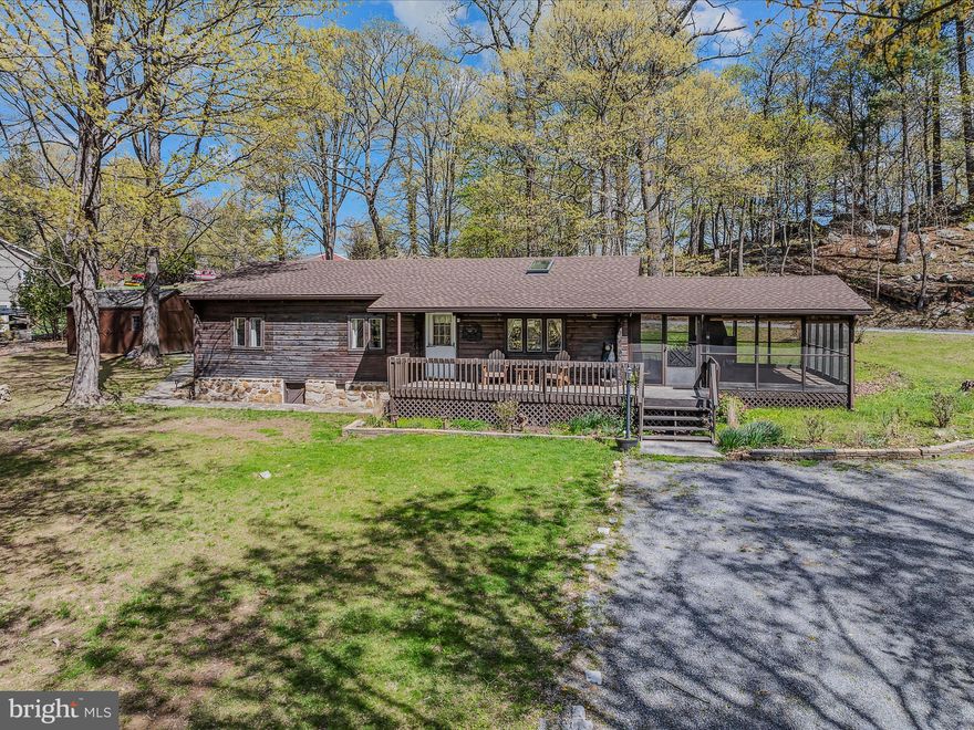 Just around the corner from downtown Berkeley Springs on 2.08 UNRESTRICTED acres-think Airbnb or home business possibilities!  This delightful log home features a beautiful recent kitchen remodel that opens the floor plan of living and dining to bring everyone together.  Living room features an electric stone fireplace for that cozy ambiance.  Three bedrooms and one bath with updates rounds out the warm home interior. A charming enclosed screened porch will entice you to entertain with a sprawling 500 sq ft of space and includes an outdoor stone fireplace to grill in!  Perfect to use 3 seasons of the year.  Plenty of space in the yard to add a garage or a nice outdoor seating area around the fire pit.  All this just a minute from dining, shopping, breweries, spas and amenities of Berkeley Springs State Park and downtown.  Cacapon State Park just 10 miles south for swimming, hiking, biking, tennis, boating, horseback riding and golfing.