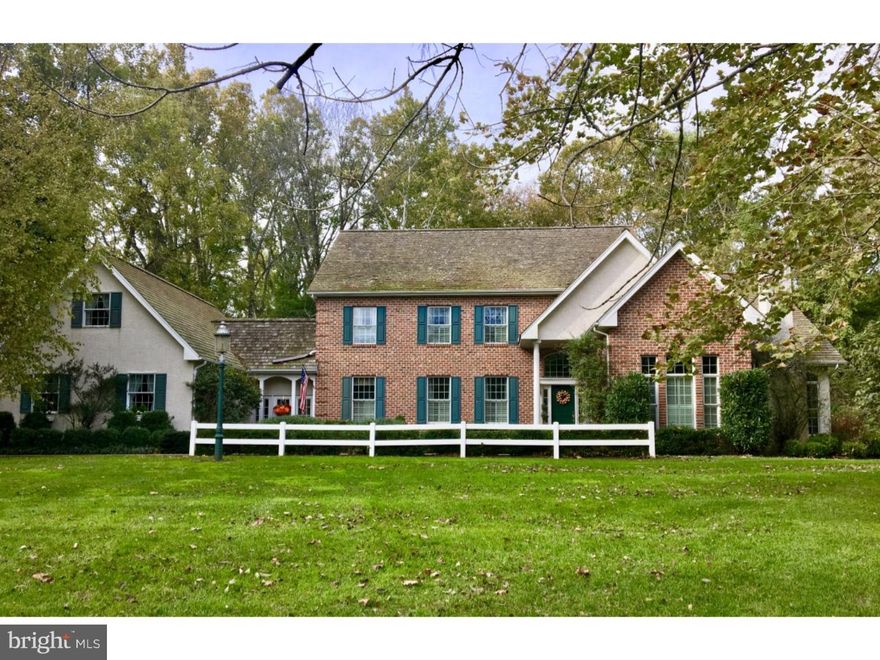 Welcome to this gracious custom brick colonial situated on a beautifully manicured and private lot in desirable Whitemarsh. As you step inside, you are greeted by an elegant staircase and a grand foyer/parlor area which adjoins the dining room and the fabulous two story great room. The open and light-filled great room offers a gas fireplace, a wall of doors and windows which overlooks the back terrace, a staircase to the second floor and custom floor to ceiling built-ins. Just beyond this dramatic space is the cozy and handsome library, also a perfect place to call an office. The comfortable eat-in chefs kitchen overlooks the magnificent gardens and offers tons of space including two island work spaces, plenty of cabinets, a pantry, a desk area and a spacious breakfast/dining area. The first floor also includes an expansive Master Suite with a lovely sitting area with a gas fireplace. The walk-in closets and huge bathroom with whirlpool tub complete this first floor suite. Upstairs, the second floor hallway overlooks the great room and includes a princess suite and  two additional bedrooms. Let's not forget the very large finished walk-out basement. You won't believe the amount of living space and storage space! Other important features include a first floor laundry room and breezeway which connects to the 3 car garage, hardwood floors, central air and gas heating, beautiful millwork and detail throughout . The lot is unlike any other. The home is set back from the road and the back yard is surrounded by woods and bordered by stone walls of what was a quarry, making this property unbelievably private.  The gracious and beautifully designed flowering garden with white picket fence reminiscent of an English garden is a little slice of heaven offering ongoing blooms throughout the season. Centrally located, minutes to area shopping, Chestnut Hill, area golf courses and so much more. Don't miss out on a wonderful opportunity to live in a turn- key home in a terrific location!