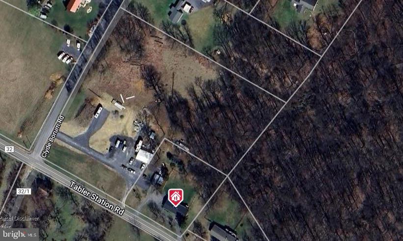 Unrestricted +/-5.6 acre corner lot fronting 2 roads with 2 easy accessible and wide entrances currently in place. 295' road frontage on Tabler Station Rd and 522' road frontage on Clyde Borum Rd with an entrance on each. This property is right off of I-81, prime for a gas station or other development. Would be the closest gas station to exit 8 off I-81. Has a well, shares a septic with the house. The garage has a bathroom in it and is currently month to month lease, tenant needs 90 days notice. Berkeley County Development Authority owns 254 acres directly across Tabler Station Rd.