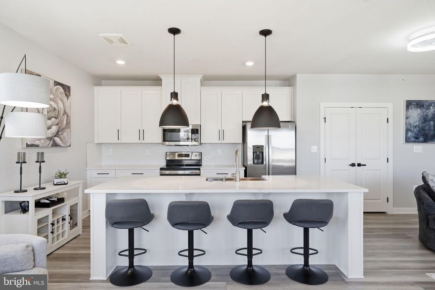 Top-Floor Modern Living with Sunset Views and a 12-Min Walk to Metro — Mosaic at Woodland Park. Experience effortless style and metro convenience in this sleek 2-bedroom, 2-bath condo in Herndon’s vibrant Dulles Tech Corridor. Positioned on the top floor, this nearly-new home offers sweeping sunset views from its private balcony, perfect for morning coffee or evening relaxation. Inside, an open-concept layout features luxury vinyl plank flooring, a quartz island, soft-close cabinetry, and upgraded stainless steel appliances—ideal for cooking, entertaining, or unwinding. Enjoy an assigned garage parking with an extra reserved space and EV charging out front, plus guest parking for visitors. Step outside to a serene courtyard and take advantage of community amenities, including walking trails, a playground, sports courts, and picnic areas with grills. Thoughtful design, move-in ready finishes, and elevator access make daily life seamless. Walk to the Silver Line Metro, Harris Teeter, Kumo Sushi, Stone’s Cove, and Woodland Park Crossing. Enjoy community trails, courts, and greens—or venture just 2 miles to Reston Town Center. Zoned for top-rated Fairfax County Schools (Coates ES, Carson MS, Westfield HS) and surrounded by major employers like AWS, Google, Microsoft, and Raytheon, this location perfectly balances work, play, and everything in between. ✔ Turnkey design & move-in ready. ✔ Elevator access & top-floor privacy. ✔ Sunset views from private balcony. ✔ Strong rental and investment potential. ✔ Steps from transit, shopping, and dining. You will LOVE living in Herndon!