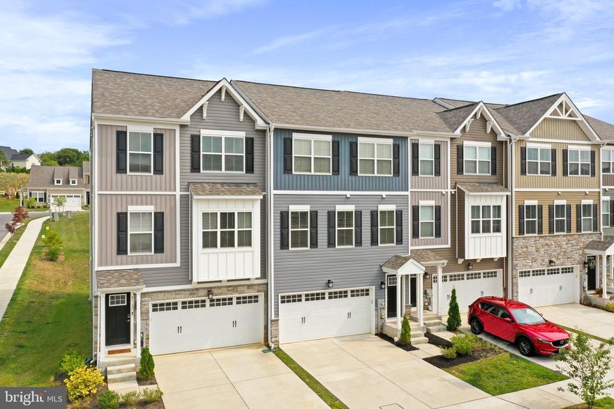 Welcome home to Snader's Summit, a newer neighborhood in the heart of Carroll County.  This lovely new community in New Windsor is finally complete.  Conveniently located only 5 miles from Westminster.  Ward Communities presents luxury townhome living with a thoughtfully designed open floor plan. The main living level features a gourmet kitchen with quartz countertops, a large center island, and ample space for gathering and entertaining. Step outside to the expansive deck—perfect for relaxing or hosting guests.
The top floor offers three spacious bedrooms, including an impressive primary suite with vaulted ceilings, a walk-in closet plus a second large closet, and a generously sized primary bathroom. Conveniently located laundry is also on this level.
The entry level includes garage access, a full bathroom with shower, and a large flexible space ideal for a home office, recreation room, game room, or additional bedroom, along with direct access to the backyard.
Enjoy low-maintenance living with a reasonable HOA that includes lawn mowing. Welcome home.