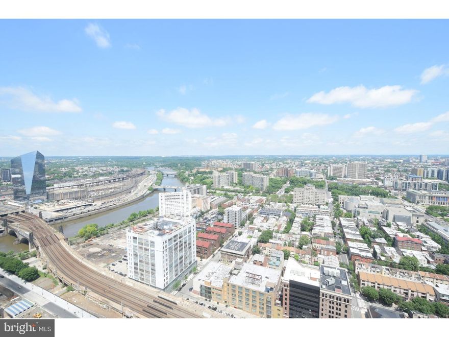 A spacious and luxurious 1400 sq.ft. Penthouse condominium with unobstructed, spectacular Northern City views including Philly landmarks like the Art Museum, Schuylkill River, Boathouse Row and the Franklin Institute all from the 40th floor! This 2bed/2.5bath residence is modern and luxurious boasting granite countertops, wood floors, stainless steel appliances, 9-foot ceilings, and floor to ceiling windows and two private balconies!! Upgrades include motorized darkening solar shades in the Mstr bedroom , custom built-in cabinets and custom closets throughout. Master bedroom has an ensuite bathroom with double sinks, separate bathtub and shower with an additional private balcony offering extended views of the city. Live like a VIP at The Murano with all it's amenities?24/7 concierge services, heated indoor lap pool, state-of-the-art fitness center, sun terrace, community room and much more. The price includes two reserved parking spaces in the attached covered garage, and a separate large storage locker with built-in shelving. As a bonus? this unit was purchased NEW from the developer in 2015. The 2nd full bathroom, range, cooktop and dishwasher have NEVER been used!