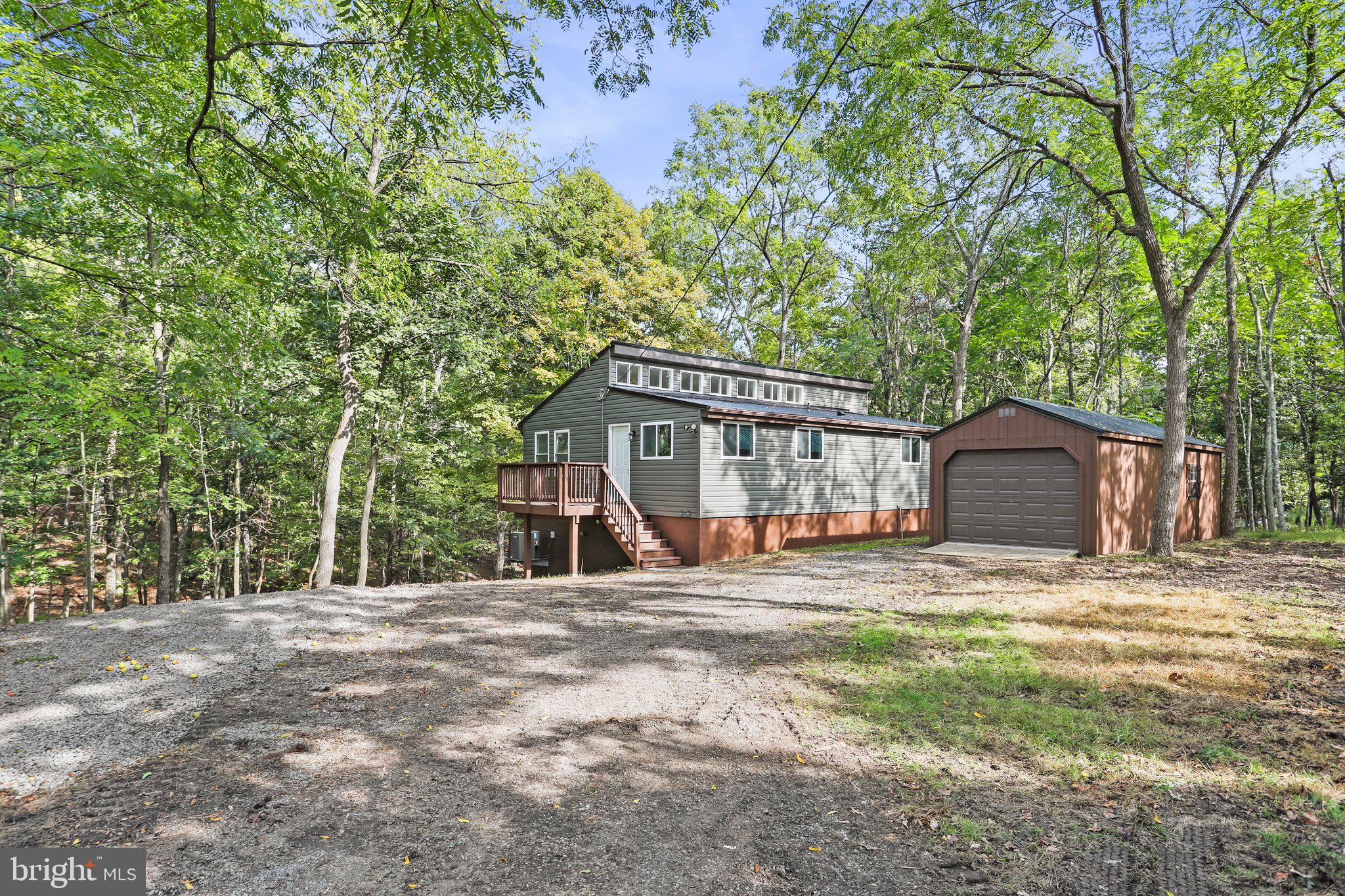 Ready for that cabin in "The Woods" well here it is! Come check out this fully renovated cabin from top to bottom in that super desirable Subdivision "The Woods Resort". This cabin is nestled in the woods and boasts a new metal roof, windows, siding, flooring, paint, appliances, heat pump, lighting, etc, the upgrades are too many to list! This tasteful chalet cabin boasts 2 bedroom and 1.5 baths, fantastic lot, detached garage. Come check this one out before its gone!
Cabin does not have a membership. However, the new owner can golf anytime with a small fee.
Would make a perfect get-a-way or airbnb!
