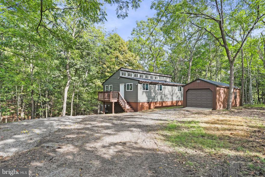 Ready for that cabin in "The Woods" well here it is! Come check out this fully renovated cabin from top to bottom in that super desirable Subdivision "The Woods Resort".  This cabin is nestled in the woods  and boasts a new metal roof, windows, siding, flooring, paint, appliances, heat pump, lighting, etc, the upgrades are too many to list! This tasteful chalet cabin boasts 2 bedroom and 1.5 baths, fantastic lot, detached garage. Come check this one out before its gone!
Cabin does not have a membership. However, the new owner can golf anytime with a small fee. 
Would make a perfect get-a-way or airbnb!