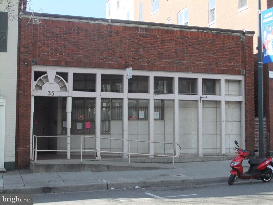 Positioned just steps from the heart of Downtown Hagerstown, this commercial opportunity offers approximately 7,800 square feet of above-grade space ideally suited for retail, office, showroom, fitness, entertainment, or specialty commercial use.
Strategically located within a two-block radius of the vibrant city core, the property benefits from outstanding walk-ability and accessibility. Nearby amenities include the renowned Maryland Theater, the multi-use recreation facility Meritus Park home to the Hagerstown Suns baseball team, multiple upscale restaurants and retail establishments, professional office buildings, the post office, two public parking decks, and an additional surface parking lot — providing ample parking options for customers and employees alike.
The main level features expansive floor space with the front section currently configured with four offices, waiting room, meeting or display areas, a boardroom/library, and a kitchen. The rear section offers a large storage area with excellent flexibility for a variety of commercial layouts and configurations. A mezzanine level includes four private offices, offering additional space ideal for administrative use, private offices, creative studios, or expanded operational needs.
At the rear of the building, a 9-foot drive-through overhead door opens into enclosed open space, creating unique possibilities for loading, secure storage, light distribution, service operations, or adaptable work areas.
With its prime downtown location, versatile layout, and proximity to key attractions and infrastructure, this property presents a rare opportunity for businesses seeking visibility, accessibility, and growth potential in one of Western Maryland’s most active commercial corridors.