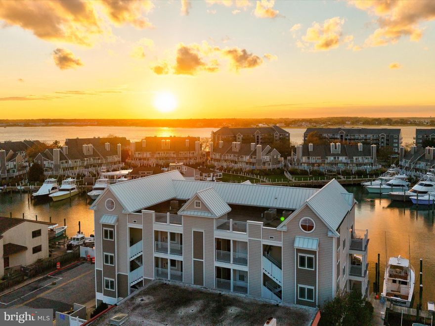 Penthouse Overlooking Harbour Island – Where Luxury Meets Legend
Location, location, location, and the views! Perched atop the exclusive Aronimink building in Ocean City, Maryland, this rarely available penthouse places you at the epicenter of coastal luxury and world-class sportfishing. Overlooking iconic Harbour Island, home of the world-famous White Marlin Open, this residence offers a front-row seat to one of the most celebrated fishing tournaments in the world, where anglers and celebrities, including the likes of Michael Jordan, gather each summer for the ultimate offshore competition.
Designed for the boating enthusiast and coastal connoisseur alike, this three-bedroom, two-and-a-half-bath penthouse is more than a home, it’s a lifestyle. Two deeded deep-water boat slips convey with the property, offering direct access to the bay, along with a covered parking space and ample storage for all your coastal gear. Whether you’re seeking a year-round retreat or an income-producing investment with short-term rental potential, this property delivers on every front. Step inside to a luxury contemporary coastal design where light and space flow seamlessly. The open concept great room is illuminated by walls of windows framing endless bay views, while coffered and cathedral ceilings, deep crown molding, and custom built-ins add layers of sophistication. A handsome corner gas fireplace anchors the living area, and a custom wet bar with wine storage makes entertaining effortless. The gourmet kitchen is a chef’s delight, boasting granite countertops that wrap the space, 42-inch custom cabinetry, and a suite of stainless-steel appliances that shimmer beneath recessed lighting. The open flow between kitchen, dining, and living areas invites conversation and connection, perfect for both everyday coastal living and lively gatherings. Atrium doors open to a sprawling balcony that spans the width of the residence, offering panoramic views of the harbor below, a prime perch for watching sunsets or taking in the energy of the White Marlin Open. It’s a space that captures the essence of bayside living. The primary suite offers a tranquil retreat, highlighted by a tray ceiling, private balcony access, and a spa-inspired ensuite bath with dual vanity, jetted soaking tub, and glass-enclosed shower. A large walk-in closet provides generous storage and organization. Two additional guest bedrooms are tucked away on the opposite side of the home, each beautifully appointed and served by a well-designed hall bath, ensuring privacy for all.
Located on 13th Street in the heart of Ocean City, you’re just steps from the Boardwalk, beaches, premier dining, shopping, entertainment, and year-round festivals that define this vibrant coastal destination. Yet when you return home, serenity takes over, where the rhythmic tides and breathtaking sunsets remind you that this isn’t just a place to live, it’s a place to belong.