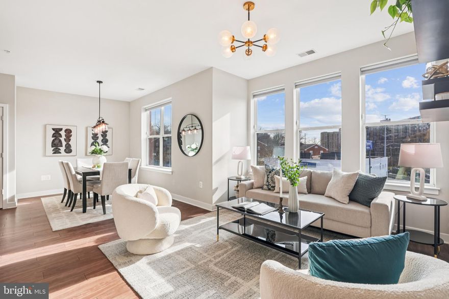 OPEN HOUSE 1-3PM on 12/7 (text 202.679.9986 to access building gate) Welcome home to Trafalgar Flats! This south facing, stunning, contemporary corner unit, the largest floor plan in the building at 1,018 square feet, offers a perfect blend of comfort and convenience. The open layout features walnut color flooring throughout the whole space and modern finishes that create a warm and inviting environment. Enjoy cooking in the open kitchen with sleek cabinets, quartz countertops, and smart appliances. The spacious living room and dining room area flow seamlessly, providing an ideal space for relaxation and entertaining. 

The spacious primary bedroom contains an en-suite full bath and custom-designed walk-in closet. Large windows in the second bedroom maximize space and natural light. For added ease, there is a washer/dryer in the unit and in-unit laundry hookups available. 

Inside the contemporary mixed-use condo development, the well-maintained common areas reflect pride of ownership. The building, constructed in 2019 with modern architectural design, features an elevator for easy access, secured main entrance, and durable construction materials. 

The community provides an array of amenities including an onsite 24-hour fitness center/exercise room, entertainment/meeting room, and a large resident courtyard with a fire pit and grills/BBQ grill area perfect for summer gatherings. Practical features include a secured bike storage room and secured package room, reserved/assigned garage parking in the basement, and association fees that cover essential services like common area maintenance, snow removal, and management. 

Located in a vibrant neighborhood, residents can enjoy nearby parks, shopping, and dining options. The location is convenient and close to restaurants along Columbia Pike, a CVS, Four Mile Run Park, and the W&OD trail. A bus stop is right in front of the building serviced by ART and Metro bus lines, and the Ballston Metro is just 2 miles away.