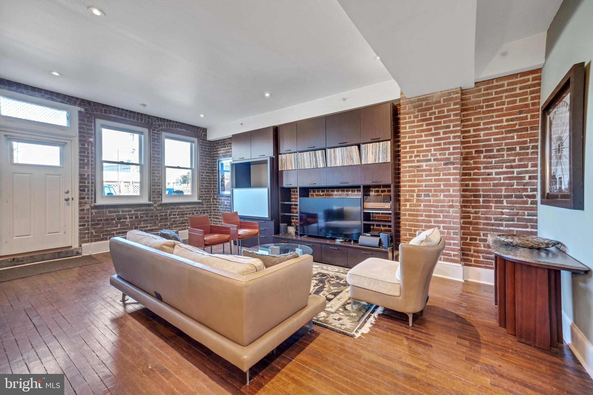 Welcome to 501 Vine St #8! This gorgeous 1 bed, 1.5 bath condo has an incredible amount of storage, it's own private spacious patio/garden and a parking spot located directly outside the unit. Enter into the bright, wide-open living and dining room space. You will be greeted by a gorgeous, exposed brick wall, high ceilings and original hardwood flooring. The open floor plan creates the perfect entertaining space. The sleek chef’s kitchen features dark wooden cabinetry, white stone countertops, subway tile, stainless steel appliances, a mini wine refrigerator and vented hood. The island provides plenty of room for dinner prep or dining and is complete with storage beneath and modern pendant lighting above. There is a large closet just off the kitchen which serves as a pantry or extra storage space. The beautiful hardwood floors continue into the bedroom suite. The bedroom features recessed lighting, two windows and is large enough to fit a king-sized bed. This space has a generously sized walk-in-closet, complete with custom built in shelving. The primary bathroom features built in shelving, beautiful neutral grasscloth tile and a modern, floating double vanity. A pocket door adds privacy to the bedroom but a transom window above allows the natural light to pass through. A convenient half bath is located off the living / dining space so guests don’t need to enter the bedroom suite. A side door leads to the shared basement steps that take you to an extra-large, private and secure storage space. The front-loading washer and dryer and all mechanicals including the central HVAC system are all located in the basement. A unique feature of this home is the spacious patio / garden space right outside the front door. With a walk score of 94, this home is steps away from Franklin Square, historic sites and the fabulous shops & restaurants in Old City and Northern Liberties. It is a short walk to Center City and conveniently located near entrances to Rt 676 and the Ben Franklin Bridge.
*On-site parking, located right outside of the unit is available for an additional $250/month. Unit can be rented with or without parking.
*The entire unit has been repainted a neutral color.