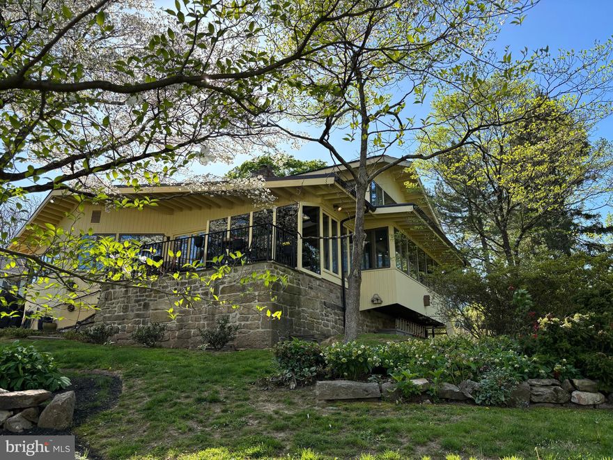 Looking for FABULOUS? This stunning 1950’s modern 2 bedroom home in Solebury has been fully updated and is move-in ready. Every inch of this  house is captivating and provides myriad spaces in which to relax, live, work and entertain. Walls of windows fill the home with natural light and offer beautiful views from every vantage point. Even before crossing the threshold of the new custom front door, visitors will know they’re entering a  one-of-a-kind masterpiece. The entry hall leads to a sleek, spacious and sunny kitchen with new appliances. Next is the dining area, large enough to  accommodate a sizable table. Just beyond is the heart of the home with a large family room, floor to ceiling brick fireplace (with separate pizza oven) and walls of windows overlooking shade trees and gardens filled with blooms. The family room opens to an enclosed sunroom and outdoor patio, both with flagstone flooring and offering front row seating for all seasons.  The remaining space on the first floor includes a large home office and gym area with custom built-ins and a separate outside exit, as well as a second bedroom and a full bath. Upstairs, the spacious main bedroom instantly brings to mind a tree-top retreat with walls of windows overlooking the rear and side yards, a separate room with walk-in closets and dressing area, and a beautiful new custom bathroom with dual sinks and over-sized walk-in shower. In addition, a new garage door, fresh paint, new wall to wall carpeting on the second floor, well tended gardens and natural lighting all add to the overall sense that the design and custom finishes of this home flow in perfect harmony. This home is located in the highly desired New Hope-Solebury School District and is just minutes from the river towns of New Hope, Lumberville and Frenchtown. It is 90 minutes to NYC and an hour to Philadelphia.