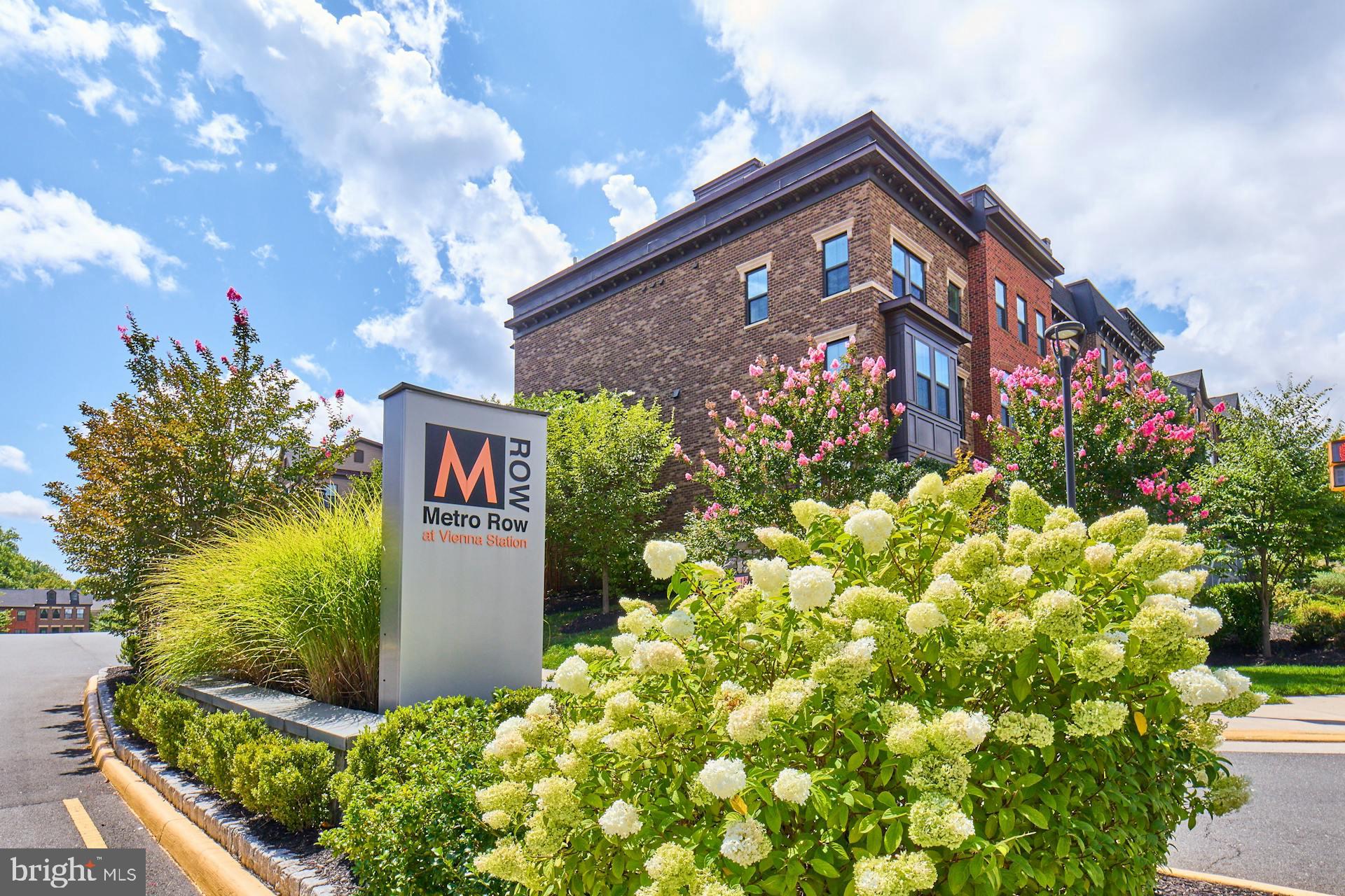 Welcome to this luxury townhome in a super convenient location, blocks to the Vienna Metro, with easy access to all major corridors, commuting routes and a short stroll to grocery, restaurants and shopping. This is one of the coveted homes in the Metro Row community with a fenced yard that backs to protected woods/trees, offering a two car garage and two car parking pad. The floorplan is ideal with a spacious main level living area, large L-shaped kitchen and dining area that opens to the covered porch. A sliding glass door invites you outside to the covered patio for alfresco dining and to enjoy the gas fireplace. You can walk-down to the fenced, grassy backyard and enjoy gardening or playtime. Some of the highlights for this home include a beautiful kitchen with a large breakfast island, custom backsplash, upgraded wood cabinetry, quartz countertops and stainless steel appliances with gas cooking and an exhaust hood. Upstairs are three nice sized bedrooms and a recently upgraded laundry room with designer wall paper and cabinetry. The primary suite features hardwood floors, two walk-in closets and a luxurious shower, soaking tub and a double vanity. The lower level is perfect as a large fourth bedroom or recreation room and features a third full bathroom. This home is move-in ready. Minimum 6 month lease.