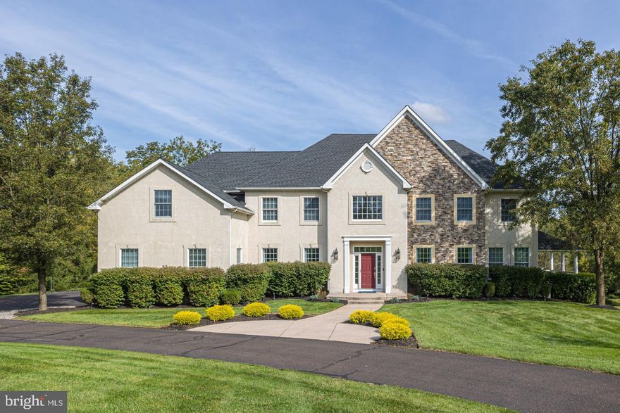 Located in Bowmans Tower Farm, just minutes away from the quaint river towns of New Hope, Lambertville and Washington Crossing is this magnificent custom home. Recently refreshed with new paint, new walnut floors, premium light fixtures, and beautiful moldings throughout, the home itself is a true gem. An open floor plan facilitates a modern lifestyle, while volume ceilings and large windows provide an airy and bright feel. As soon as you step inside, you’ll immediately notice the stunning hardwood floors and the striking grand staircase with wrought iron balusters. An inviting dining room with a new decorative accent wall provides great space for hosting celebrations and holidays. Ideal for entertaining, a convenient butler’s pantry leads to a gourmet kitchen equipped with everything you need: high-end stainless appliances, walk-in storage pantry, granite countertops and a 2-tier island with seating. Filled with a natural abundance of light, the 2-story breakfast area is surrounded by windows and has access to the newly installed maintenance free deck. Adjacent to the kitchen is the sizeable gathering room with new gas fireplace and a wall of windows overlooking the picturesque woodland buffer. A study tucked off the great room offers a private refuge inside and access to a tranquil, side porch overlooking the gardens. Completing the main floor is a music room, a bonus room which could be used as an additional office, craft, or wine room, a spacious mud room, and a newly updated half bath. Head upstairs via the main or rear staircase to a large overlook enjoying the view of the rooms below. The main bedroom suite offers a sitting area, enormous walk-in closet, and spacious main bath complete with sauna. Two additional bedrooms, one with its own sitting area, share a full bath with dual vanities and a third bedroom enjoys access to an adjoining full hall bath. A spacious, sunlit, fully finished walkout lower level adds to the entertainment space and offers a full bath, bonus room, ample storage and access to the rear patio. Additional home amenities include a 3 car garage, 45KW whole house generator with automatic transfer switch, integrated sound and lighting system, and Tesla chargers on a beautiful nearly 2 acre lot. Easy access to shopping and dining in Newtown and New Hope and commuting to Princeton, NYC and Philadelphia. Walking distance to Bowman’s Tower Park, Wildflower Preserve and Bowman’s Tavern. All of this in award-winning Council Rock School District. Just move in and enjoy!