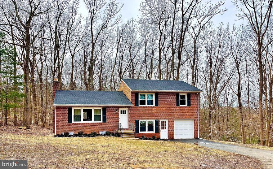 Sensationally Renovated and Spacious Home in Towson! Idyllically nestled on a 1.85 acre lot in a highly coveted area, this 3BR/1.5BA multi-level residence impresses with a gorgeous brick exterior, beautiful mature trees, and neat landscaping. Designed for inspired living, the stylish and remodeled interior entices with refinished hardwood flooring, tons of shimmering natural light, fresh neutral paint, and an expansive living room with a well-appointed fireplace. 

Entertain family and friends in the brand-new gourmet kitchen, which features stainless-steel appliances, gleaming granite countertops, a center island, a built-in microwave, a dishwasher, white shaker cabinetry, and an adjoining dining area. 

Host year-round gatherings in the sprawling backyard with stone patios, a sizeable fenced area, and tons of room for lounging and al fresco dining! Boasting a whimsical backdrop of trees, greenery, and occasional deer, the outdoor space is also perfect for relaxation, wine, or morning coffee. 
During cold winters, take advantage of the basement and create a man cave, lady lair, home gym, or art studio! All three bedrooms are abundantly sized with dedicated closets, while the remodeled full bathroom elevates self-care routines with a dual sink vanity, premium finishes, classic tilework, and a shower/tub combo. On the lower-level, you find a potential 4th bedroom/home office, a half-bathroom, a laundry area, and convenient garage access. 

Other features: attached 1-car garage with new garage door and remote, tons of storage throughout, a new roof, new windows, new central heating, new air conditioning system, Comcast high-speed internet available, only 3.3-miles from Towson University, quick 15-mile drive from Downtown Baltimore, close to excellent shopping, restaurants, Cromwell Valley Park, Whole Foods, 3 miles or less from elementary, middle and high schools, and much more! Schedule your tour now!