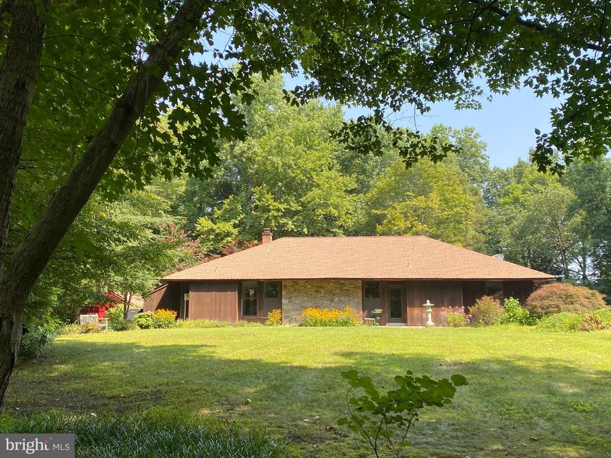 14400 Molly Berry Road is located in the rolling hills of Southern Prince George County. This one-of-a-kind home sits on 12 wooded acres containing large poplar, oak, hickory and pine trees. The main drive features three varieties of dogwoods and Rhododendron, planted 30 years ago. A truly custom-built house constructed with 2x6 heart of red wood and stone siding. Six-inch walls provide superior insulation and sound proofing.  Pella windows and doors provide additional insulation. Radiant heat in flooring delivers efficient heating and contributes to higher air quality. Passive solar heat from large south facing windows generate heat in winter while roof overhang shades windows in summer.  Property includes a detached studio apartment perfect for rental income, great room with large stone fireplace, storage room, 4 car garage, basement walkout room w/half bath suitable for home office or guest bedroom, recreation room separated by breezeway. New air conditioning for main house installed in 2021, new air conditioning & furnace installed for studio apartment in 2021. The Patuxent River is  1 mile away as the crow flies. Access is  3 miles to Clyde Watson boat ramp or Jug Bay Park. Welcome home!