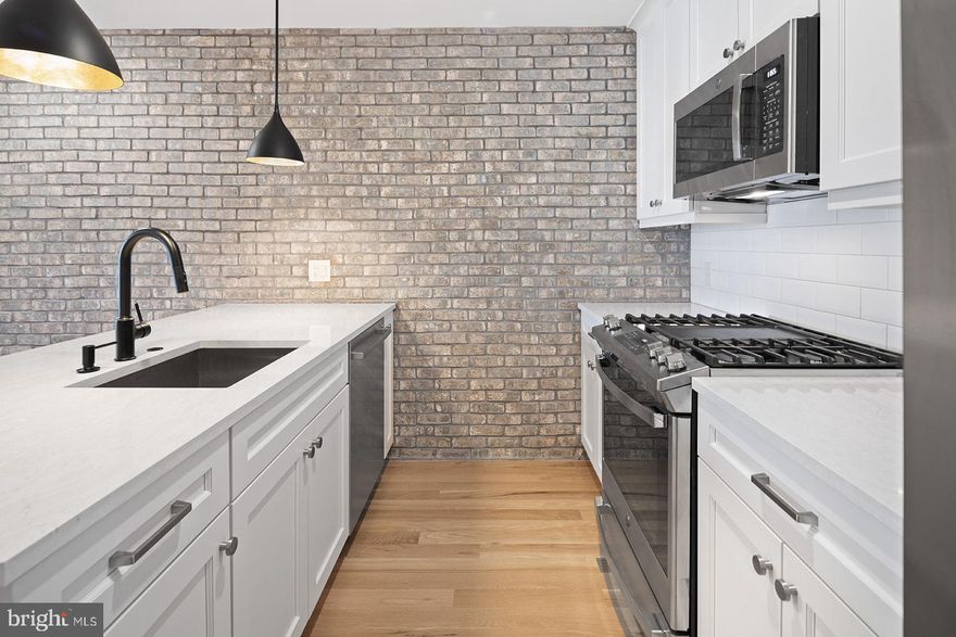 Beautiful boutique building in Northern Liberties! 2 bedroom with 1.5 bath apartment  with a private balcony and a common roofdeck. This unit features hardwood oak floors (which were sanded in place) quartz countertops and top of the line appliances like a Bosch French Door Fridge and a 5 burner GE stove, in unit laundry with a designated shelved closet, dishwasher, over the range microwave, garbage disposal and designer lighting in the kitchen and bathrooms. The primary  bedroom will fit a king sized bed and has a California Closet, The secondary bedroom will fit a full sized bed and also has a California Closet.  The building has a common roofdeck which offers a great view for fireworks. With a walk score of 98, you will never get bored. Imagine living steps away from wonderful places like Philadelphia Distilling, The Filmore, Standard Tap, Bourbon and Branch and plenty more. Less than a 5 minute walk from the Spring Garden Market-Frankford line. Now doing in person showings. Price reflects one months rent concession