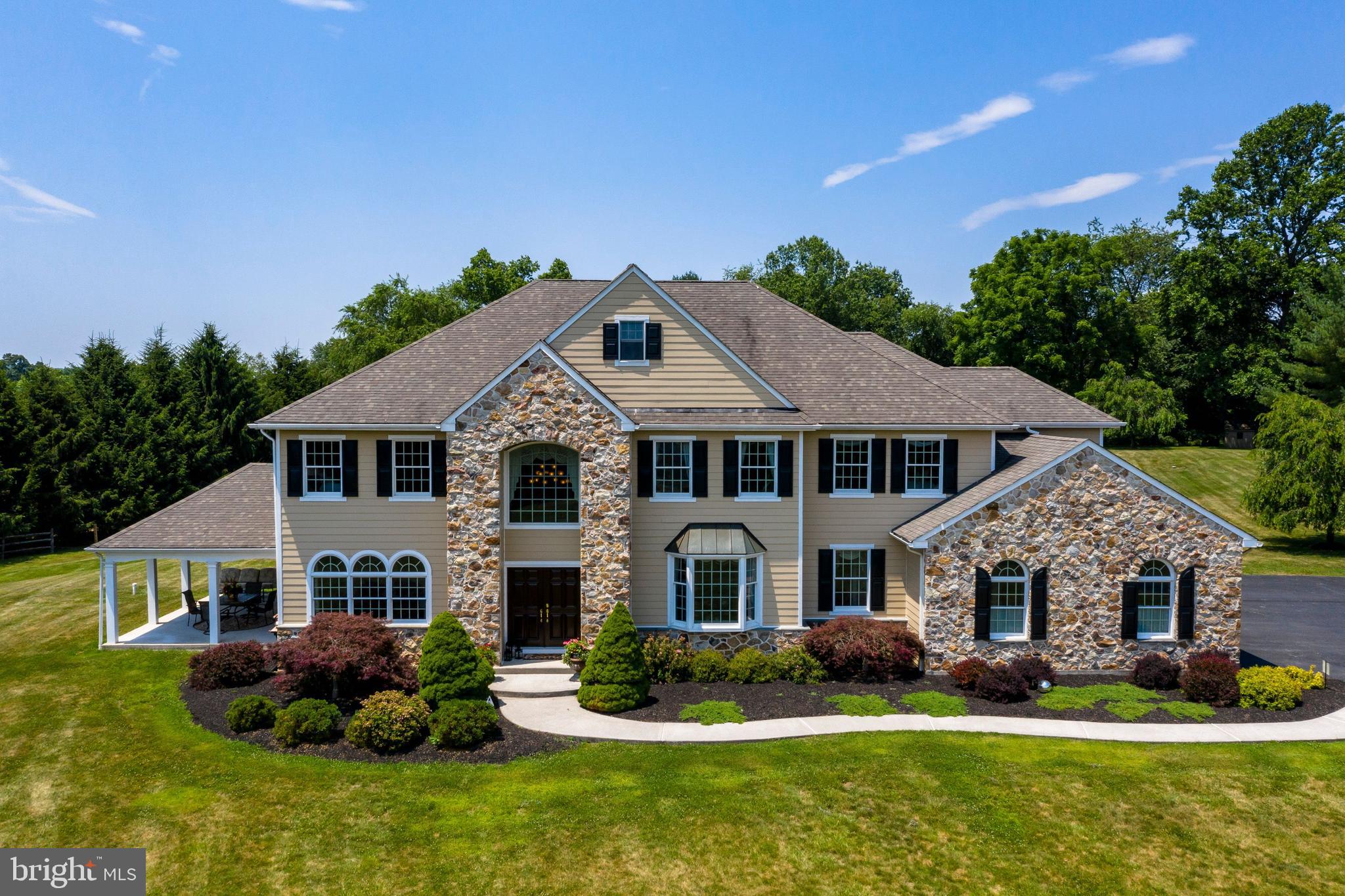 Welcome to an oasis in the heart of the true Chester Springs, West Pikeland Township, in the award winning, Downingtown Area School District.  Just off Yellow Springs Road, enter the tree-lined Braefield Road,  past grazing horses, stunning views and landscape,  into this sought-after development of just nine architecturally significant homes on four to ten acre lots.  1131 Braefield Road, sited on a four acre, level lot on a private cul-de-sac, is a stately home, with outdoor living areas that offer magnificent views from every angle.   A seventy acre township park borders the community, as well.  Walk to soccer fields, a pavilion, playground, walking trails and Saturday morning Yoga in the summer months. Authentic Chester County stone and recently installed HardiPlank siding provide a stunning, near maintenance free exterior.  Distinctive, custom appointments like gorgeous red birch hardwoods, a cherry, hardwood staircase, coffered ceilings, custom built-ins, stunning custom cabinetry, porcelain tile flooring, granite counters and tile backsplash are just some of the outstanding elements of this special home.  The gourmet kitchen has new stainless appliances, including a GE Monogram gas cooktop, and Fisher-Paykel double oven and dishwasher.   Other exquisite features include custom, crown molding in the living room, front hall, office, dining room, and mudroom, custom built-in bookshelves in the family room,  as well as a stunning, crystal Schoenbeck tiered chandelier.  Professionally decorated with custom window treatments.   Enjoy breathtaking views of the countryside and the 30,000 gallon, custom Carlton swimming pool from the numerous, architecturally interesting windows, which allow wonderful natural light throughout. Five ample bedrooms, including a lovely master suite, along with a floored, walk-up attic are on the second and third levels.   A beautifully finished basement is another wonderful feature of this home that makes it an exceptional value.  Also included in this unique property and location is a four bay garage.  This home is one with beauty, elegance, stunning vistas.   Breath-taking charm and ambiance.  Another unique feature of this custom home is a large side porch with roof.  Enjoy having dinner and relaxing in this cathedral roof porch enjoying the comfort of a gentle breeze overlooking the expanse of rolling hills.  This home's property and location is like no other!