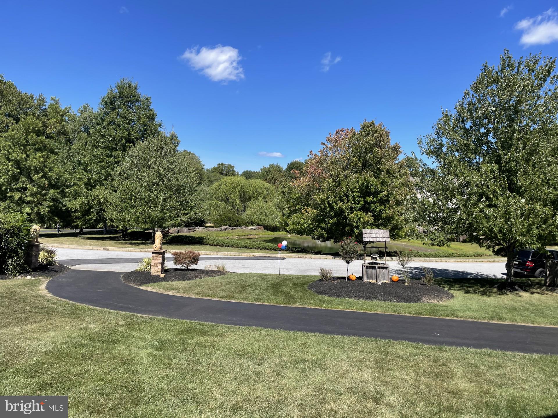 Spectacular is an understatement; one of a kind former Pondview model home nestled on a premium .9 acre private level lot looking out over a beautiful pond across the street, situated in the heart of Garnet Valley and top rated Garnet Valley school district. A beautiful grand stone facade and main front entrance walks into a breathtaking cathedral foyer entrance where you're greeted by endless upgrades & top end finishes including endless custom millwork, custom stonework, gleaming wood floors that flow throughout a lovely open floor plan, 10' ceilings and much, much more. Only available due to downsizing/relocation, this fabulous upgraded and lovingly maintained home has 5 spacious bedrooms on the upper level with private access to 4 full baths and every closet is fitted with custom closet organizers. The luxurious master suite is exceptionally spacious; featuring a pan ceiling, crown moulding, a large sitting room, two large walk in closets with custom built in organizers, and a fabulous tiled master bath with with an oversized walk in tiled rainfall shower, his & her double vanity and a separate water closet. For optimum convenience the laundry is also situated on the upper level. The main level living area features a spacious family room with a cozy fireplace that is adjacent to the gourmet kitchen with beautiful upgraded Century cabinetry, an oversized center island, a large pantry, custom millwork and custom stone accent wall, crown moulding, stainless appliances including double ovens, microwave, dishwasher and cooktop, a vented hood and a commercial grade sub zero refrigerator, lovely double thick granite counters and a beautiful sunny morning room featuring a vaulted ceiling that walks out to a rear deck looking out over the large private rear yard backing to trees and nature abounds. Also adjacent to the kitchen is a grand formal dining room and living room suite with a lovely wood burning fireplace, crown moulding, chair rail, farmhouse wall panel, and there is a spacious private office with a bay window looking out over the front yard and a lovely pond across the street, a conveniently situated half bath and a mudroom with a large coat closet that has custom built organizers leading to the two garages for three cars and all your toys. There is even a custom sport court and basketball hoop outside for the sports enthusiast. The finished lower level adds another 1,592 square feet of stunning finished living space with a great room featuring a fantastic built in granite wet bar, custom stacked stone and distressed pallet accent walls, a professional grade theater with a 110" screen and state of the art projection and sound system as well as tiered leather theater seating, and a full bath, plus unfinished storage / utility rooms and an exercise room (not counted as finished space). Centrally located to the Garnet Valley School campus, the Concord Township Park, Walking & Running Trails, Dog Parks, Rachel Kohl Library, the Brandywine Youth Club sports fields and field-house, dance studios, Darlington Arts Center & all commuting routes to corporate centers, Delaware tax free shopping, airports, Philadelphia, Wilmington, Media, West Chester & more. This exceptional well maintained home is a must see and is truly move in ready. Showings begin Sunday September 8th; schedule a tour of this spectacular home today or come to the open house scheduled for Sunday September 8th from 12 PM to 4 PM.