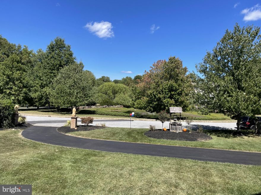 Spectacular is an understatement; one of a kind former Pondview model home nestled on a premium .9 acre private level lot looking out over a beautiful pond across the street, situated in the heart of Garnet Valley and top rated Garnet Valley school district.  A beautiful grand stone facade and main front entrance walks into a breathtaking cathedral foyer entrance where you're greeted by endless upgrades & top end finishes including endless custom millwork, custom stonework, gleaming wood floors that flow throughout a lovely open floor plan, 10' ceilings and much, much more.  Only available due to downsizing/relocation, this fabulous upgraded and lovingly maintained home has 5 spacious bedrooms on the upper level with private access to 4 full baths and every closet is fitted with custom closet organizers.   The luxurious master suite is exceptionally spacious; featuring a pan ceiling, crown moulding, a large sitting room, two large walk in closets with custom built in organizers, and a fabulous tiled master bath with with an oversized  walk in tiled rainfall shower, his & her double vanity and a separate water closet. For optimum convenience the laundry is also situated on the upper level.   The main level living area features a spacious family room with a cozy fireplace that is adjacent to the gourmet kitchen with beautiful upgraded Century cabinetry, an oversized center island, a large pantry, custom millwork and custom stone accent wall, crown moulding, stainless appliances including double ovens, microwave, dishwasher and cooktop, a vented hood and a commercial grade sub zero refrigerator, lovely double thick granite counters and a beautiful sunny morning room featuring a vaulted ceiling that walks out to a rear deck looking out over the large private rear yard backing to trees and nature abounds.   Also adjacent to the kitchen is a grand formal dining room and living room suite with a lovely wood burning fireplace, crown moulding, chair rail, farmhouse wall panel, and there is a spacious private office with a bay window looking out over the front yard and a lovely pond across the street, a conveniently situated half bath and a mudroom with a large coat closet that has custom built organizers leading to the two garages for three cars and all your toys. There is even a custom sport court and basketball hoop outside for the sports enthusiast.   The finished lower level adds another 1,592 square feet of stunning finished living space with a great room featuring a fantastic built in granite wet bar, custom stacked stone and distressed pallet accent walls,  a professional grade theater with a 110" screen and state of the art projection and sound system as well as tiered leather theater seating, and a full bath, plus unfinished storage / utility rooms and an exercise room (not counted as finished space).  Centrally located to the Garnet Valley School campus, the Concord Township Park, Walking & Running Trails, Dog Parks, Rachel Kohl Library, the Brandywine Youth Club sports fields and field-house, dance studios, Darlington Arts Center & all commuting routes to corporate centers, Delaware tax free shopping, airports, Philadelphia, Wilmington, Media, West Chester & more.   This exceptional well maintained home is a must see and is truly move in ready.  Showings begin Sunday September 8th; schedule a tour of this spectacular home today or come to the open house scheduled for Sunday September 8th from 12 PM to 4 PM.