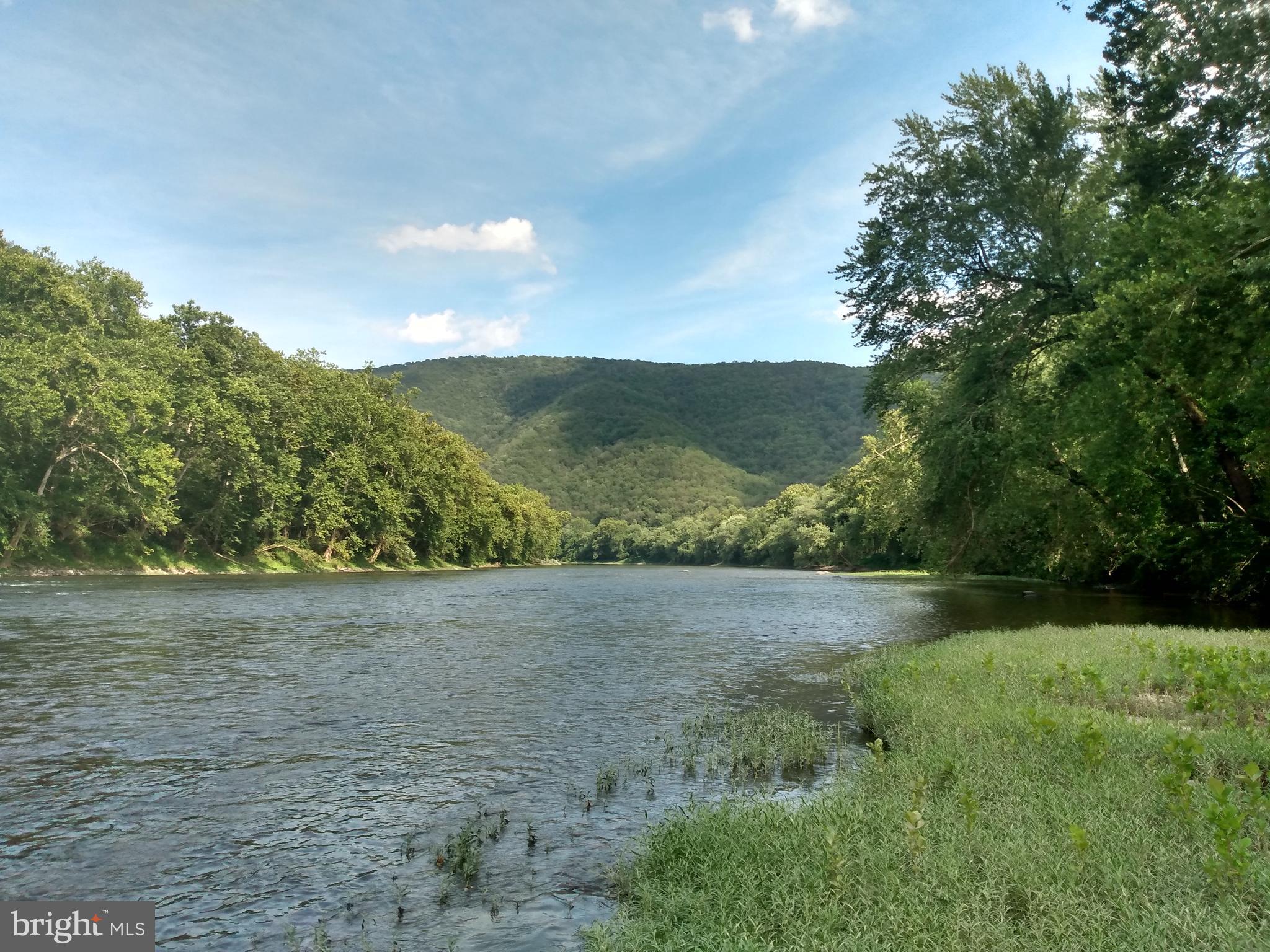 POTOMAC RIVER FRONT! over 98 acres of Pristine WV Woodlands with 2,000 feet of river frontage that includes a camping area with easy access to the water's edge, across the river you'll find the C&O canal route for Biking and Hiking along with State Parkland enhancing the serenity and everlasting natural beauty. This land is not mountain land, it is mostly level with some rolling deviations to the terrain, covered in mature hardwoods. With numerous areas for building this is a perfect location for multiple dwellings, if that's in your plans, You'll find a secluded pond and mountain stream within the property. The older homestead built in 1911 shows a lot of character and seems to be mostly original, with a modern well and septic system along with a newer roof on the main section, this home is included as a bonus and is sold strictly AS-IS. You can sit on the front porch or observation deck and watch the trains roll by, if you're a train enthusiast you will appreciate the rich history of Orleans Cross Roads. Building that dream home further back on your land may also be in the plans. An excellent location for Hunting, Fishing, Boating, Swimming, and this parcel presents potential for timber management and subdividing.
Located within 2.5 hours of Washington DC, Baltimore MD area and near Berkeley Springs WV, this Piece of Paradise is easy to access from the county black top road. If you're looking for a Larger Unrestricted Parcel of Land this is one you'll not want to miss, Call Today!