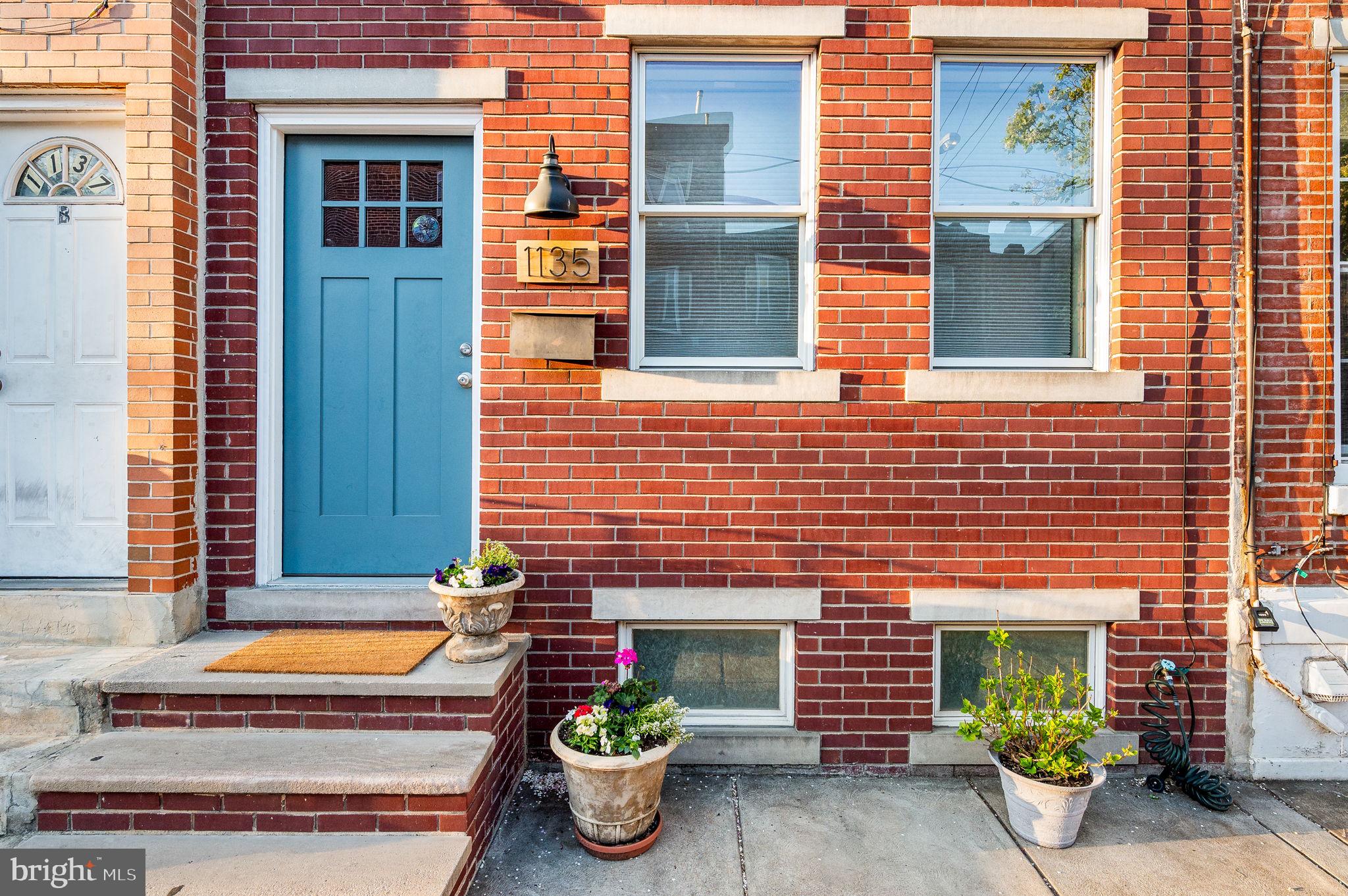Here is your moment! This beautiful, loft-style 3 BEDROOM, 2 FULL BATH townhome is just steps away from the shops and restaurants of Passyunk Square and the Italian Market. Featuring an open layout, BEAUTIUFL SOLID WOOD FLOORING on the first and third floors, recessed lights, and all RENOVATED KITCHEN, BATHROOMS AND UTILITIES , you will move right in! The front Living room floods with SUNLIGHT shining over to the inviting EXPOSED BRICK, crown molding and ceiling mounted flat panel TV. Your dining room is conveniently placed by the BACK PATIO and KITCHEN with stone tile floors, stone back splash, GRANITE countertops, and all STAINLESS STEEL appliances. Retreat to your PRIVATE BACK PATIO for serene al fresco dining, gardening or BBQ. The WROUGHT IRON STAIRS are an appealing entry to the 2nd floor where 2 ample-sized carpeted bedrooms with plenty of closet space (the front bedroom has a walk in closet!) and a FULL HALL BATH WITH TUB AND SHOWER await. Hall bathroom includes tile floor, bathtub and generous tiled stall shower. And then up to THE AMAZING 3RD FLOOR PRIMARY SUITE where city views abound. The bath includes his and her vanities with vessel sinks and A WALKIN SHOWER STALL WITH CUSTOM TILE DETAILING. And the bedroom includes a wall wide built in closet as well as the original closet, so you are never out of storage.
FINISHED BASEMENT for work or play adds to the functional living space. Central Air. LAUNDRY AND STORAGE ROOM. 1782 SQAURE FEET.
2 blocks from the Broad Street Subway, makes ACCESS TO CENTER CITY AND THE STADIUMS a breeze. Don’t miss this rare opportunity to own a piece of Philadelphia history in one of its most sought-after neighborhoods!