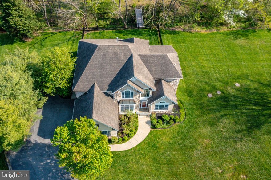 Welcome to this Striking 5BR, 5.5BA Retreat Located on a Private  2.2+ AC Lot - The Curb Appeal is Breathtaking!  Classy, Premium Exterior Finishes Accented by Stone, Dryvit, Hardi-Plank Siding, Elegant Wrought Iron Fenced Yard, 54’ x16’ Patio, 46' Deck, & 3-Car Side Load Garage!  You'll Find Pristine Oak Flooring Throughout the Main Level * Fabulous Floorplan Featuring  a Main Level Owner’s Suite w/Tray Ceiling w/Cove Lighting  and Primary Bath w/Whirlpool Tub, Separate Shower & Dual Vanities w/Granite Counters * Enjoy Entertaining in the Voluminous, Sun-Filled 2-Story Living Room w/ 2-Sided Gas FP, HI/Low Windows & Doors Opening to Expansive Deck w/Stairs to the Back Yard * Banquet Sized Dining Room w/Heavy Moldings & Triple Window w/Palladian Accent *  Butler’s Pantry w/Maple Cabinetry * Double French Doors Open to Office w/Vaulted Ceiling & Triple Window w/Palladian Accent * Gourmet Chef's Kitchen w/Weathered White Cabinetry & Maple Cabinets on Island, Pull-Out Shelving, Granite Counters, & SS Appliances * 2-Story Breakfast & Family Rooms w/Imposing Stone Floor-to-Ceiling 2-sided Gas FP & Door Opening to Deck * Laundry/Mud Room w/Sink & GE W/D * Lovely Oak Staircase  leads to Upper-Level w/Brand New Luxurious Carpet & Overlooks to Living Room & 2-Story Foyer * Two Bedrooms w/Updated En Suite Baths PLUS Two Bedrooms joined by an Updated “Buddy Bath" * Wood Staircase Leads to Lower Level w/Brand New Luxurious Carpet * Sprawling 60’  Daylight  Walk-Out Clubroom w/Rough-in for Future Bar Sink, 5th Full BA, & 57' Storage/Utility Room * Professionally Painted Throughout * Andersen Windows & Doors * 9' Ceilings on Lower & Upper Floors * Security System * New Pressure Tank 2024 *  New Well Pump 2022 *  Dishwasher & Refrigerator @2-3 yrs * W/D @5 yrs * The Deck was Rebuilt 2 or 3  years ago * Walk through the Back Gate and Cross Over the Bridge to See the Intriguing Statue at the Back Edge of the Yard!