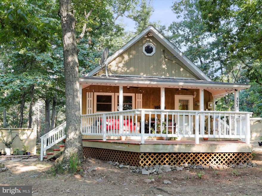 Escape the city and unwind in this charming mountain cabin, nestled in the serene surroundings of Peaceful Valley Estates. Just a two-hour drive from Washington, D.C., this classic cabin offers the perfect getaway for those seeking tranquility and adventure. With 691 sq. ft. of inviting living space, this cabin features 2 bedrooms and a full bathroom, providing a comfortable retreat for you and your loved ones. Situated on a generous 4.63-acre double lot, the property offers privacy and room to explore, ensuring your own slice of mountain paradise. Recent enhancements include a brand-new roof and a spacious rear deck, perfect for relaxing and entertaining in the fresh mountain air. The property also includes a 280 sq. ft. guest quarters, ideal for hosting friends and family, making it a great spot for weekend gatherings. Enjoy evenings around the stone fire pit, sharing stories and enjoying the great outdoors. Ample outdoor storage ensures plenty of space for your recreational gear. Located near thousands of acres of public land, including the renowned Nathaniel Mountain Wildlife Management Area and Short Mountain Wildlife Management Area, you'll have endless opportunities for hiking, hunting, and exploring the stunning West Virginia wilderness. Whether you're seeking a peaceful weekend retreat or a full-time residence, this mountain cabin offers the perfect blend of comfort and rustic charm. Embrace the weekend warrior lifestyle and create unforgettable memories in your own West Virginia haven. Don’t miss this chance to own a picturesque cabin retreat within easy reach of the DMV.