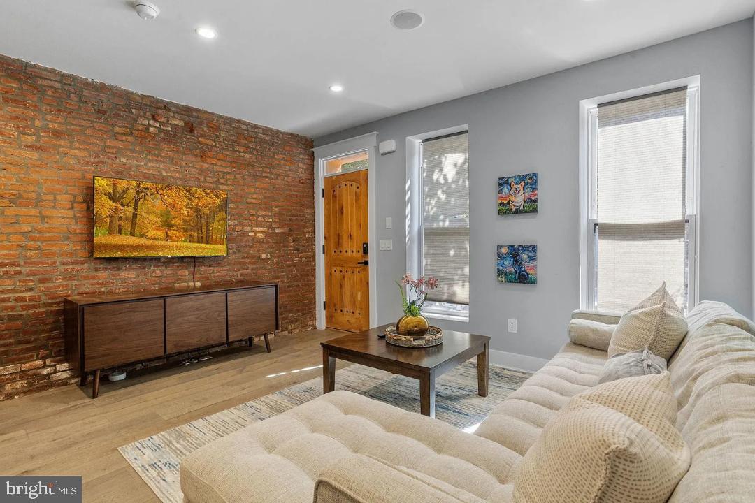 This 3-bedroom, 2.5-bath home offers the perfect blend of modern amenities and timeless charm. Step inside to a bright and inviting living area featuring gleaming hardwood floors and custom details throughout. The open layout flows seamlessly into the dining area and a stylish powder room, while the beautifully designed kitchen boasts stainless steel appliances, quartz countertops, and ample storage. A striking exposed brick wall leads to the second floor, where you’ll find two spacious bedrooms and a full bath. The third floor is dedicated to the luxurious primary suite, providing a private retreat with plenty of space to unwind. Enjoy additional living space in the finished basement, perfect for a home office, gym, or entertainment area. Laundry in unit. Outside, the large fenced rear yard offers endless possibilities for outdoor enjoyment, while the expansive roof deck provides breathtaking views—ideal for relaxing or entertaining. This exceptional home is a must-see!