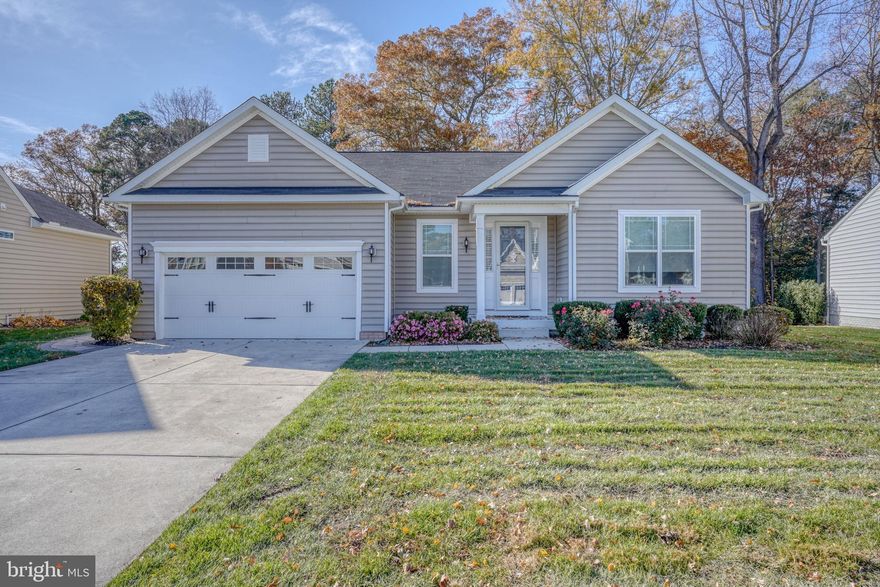 Premium wooded lot with pond views! Embrace coastal living in this beautifully appointed 3-bedroom, 2-bath St. Michaels model located in the amenity-rich community of the Villages at Red Mill Pond North, featuring nearly 2,300 square feet of living space. Offering the ease of one-level living with thoughtful upgrades throughout, this home perfectly blends comfort, style, and functionality. Step inside to find 9’ ceilings, engineered hand-scraped hardwood flooring throughout, and a bright, open-concept layout. The spacious living area features a cozy gas fireplace with built-ins, while the adjoining morning room showcases peaceful views of the trees and pond—bringing the outdoors in. The gourmet kitchen is designed to impress with granite countertops, stainless steel GE profile appliances, a gas cooktop, double wall oven, center island with bar seating, and a corner pantry. A versatile, small flex room provides the perfect space for a home office or additional storage. The primary suite with walk-in closet offers a relaxing retreat with an en suite bath featuring a tile step-in shower with bench and two shower heads, double vanity with ample cabinetry storage, water closet and large linen closet. The split floor plan offers privacy, with two guest bedrooms and a shared full bath separate from the primary suite. Additional highlights include a laundry room with utility sink and cabinetry, a conditioned 4’ crawl space with full interior access for abundant storage, gutter guards, irrigation system with agricultural well to save on water costs, and a 2-car attached garage. Enjoy outdoor living on the spacious paver patio overlooking a private, tree-lined, fully fenced backyard with tranquil pond views—ideal for relaxing or entertaining. Low-maintenance living at its best, with lawn care included in the HOA. Residents enjoy exceptional amenities, including a pond-front screened gazebo and private kayak launch onto Red Mill Pond, along with two clubhouses, two fitness centers, two outdoor pools, pickleball courts, billiards room, poker room, and more. Direct access to the Georgetown-Lewes Bike Trail makes staying active easy and enjoyable. Your coastal lifestyle starts here—don’t miss this opportunity!