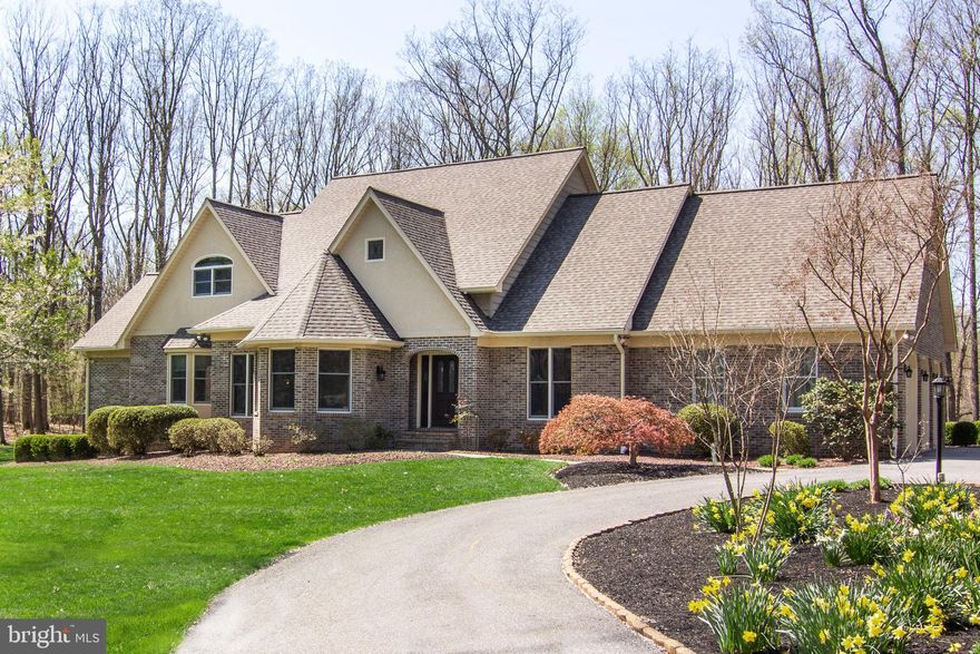 Make your appointment today to see this stunning 2-story Custom Colonial with approximately 5,200 sq. ft. of finished living space. This includes 5 bedrooms, 4 full baths, 1 half bath, 32' x 22' 3 car garage and finished lower level.  Relax and enjoy your coffee in the morning admiring the wildlife on your private 3-acre wooded lot. The gourmet kitchen is perfect for all your entertainment needs. This includes a sub zero refrigerator, granite countertops, stainless steel appliances, recessed LED lighting and island with stovetop. Easy access laundry room on main floor with front load washer/dryer. Upgraded powder room. Lovely 1st floor Master Suite with bay window and window seat w/storage, and direct access to the deck through an atrium door.  Recently remodeled master bathroom with expansive glass-enclosed shower and luxurious freestanding tub. Relax in your 1st floor family room while enjoying the wood burning insert. The living room has built-in wooden shelves and hardwood floors. The large dining room with vaulted ceilings and built-in hutch is perfect for all family gatherings. Impressive 2-story foyer.  Hardwood floors throughout most of the 1st floor, as well as the upper floor loft/sitting room and upstairs hallway. 2 of the 3 bedrooms on upper level have walk-in closets and full baths. The lower level provides a large family room/rec room, wet bar with granite top, fitness area and 5th bedroom with upgraded full bath - perfect for a Millennial Suite. Enjoy the sunset from the 24' x 24' wooden rear deck ideal for entertaining. Gorgeous detailing throughout this home. Circular driveway with extensive landscaping. Improvements consist of new roof/gutters 2015, refinished Dryvit on front of house 2016, refinished Dryvit on outside of chimney 2019. Other upgrades/improvements consist of water softener, neutralizer, sump pump and heat pump. Plenty of storage space. This home is gorgeous and move-in ready.