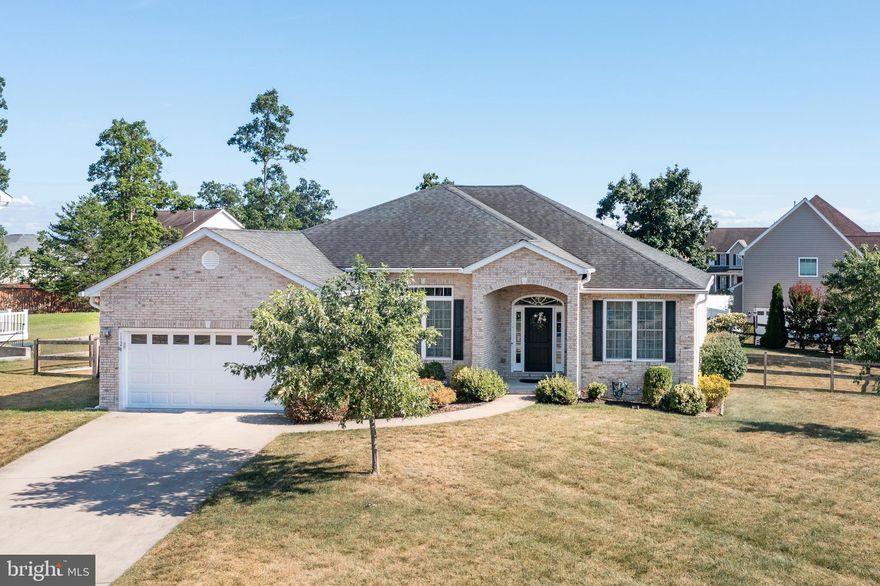 Located in sought-after Sovereign Village on Winchester’s desirable east side, this beautifully maintained home offers the ease of main-level living without sacrificing space, functionality, or style. Thoughtfully designed with an open feel while still maintaining traditional spaces, the layout includes a formal dining room, an additional living room or office, and a spacious family room centered around a beautiful gas fireplace. Large windows, soaring ceilings, and an abundance of natural light give the home an airy, welcoming feel from the moment you walk in. A smart mix of hardwood flooring, tile and carpet adds warmth and practicality throughout the home. The kitchen was designed with both everyday living and entertaining in mind, featuring an eat-in area, bar overhang seating for guests, and easy access to the covered deck overlooking the beautifully landscaped backyard. Outside, the hardscape, extensive landscaping, and fully fenced yard create a private outdoor space that is ready to be enjoyed. Positioned on a corner lot, the property also offers an added sense of openness and extra green space around the home. The main-level primary suite is privately situated just off the kitchen and features an attached en suite with a jetted tub, walk-in shower, water closet, and spacious walk-in closet. Three additional bedrooms on the main level provide flexibility for guests, hobbies, office space, or family needs. Downstairs, the massive unfinished walk-up basement offers exceptional storage and incredible potential for future finished living space. Already wired for electric, heating and air, and partially studded, much of the groundwork has already been completed for future expansion. Additional features include garage storage shelving and racks, covered outdoor living space, and a location that is hard to beat for commuters. Just minutes from Route 7, shopping, restaurants, Starbucks, and downtown Winchester, this home offers convenience while still being tucked away on the desirable east side of town. Beautifully cared for and designed for comfortable everyday living, this property offers the flexibility, convenience, and layout you might just be searching for.