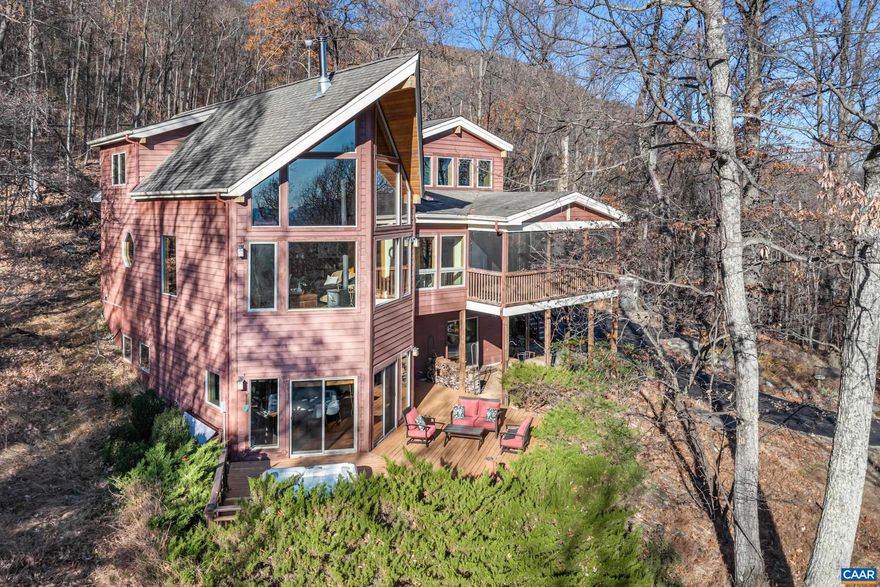 A NEWLY PAVED DRIVEWAY leads up to this stunning post & beam mountain home on private woodland parcel with VIEWS! Welcome to Yamanaka, meaning "In the mountains". Total PRIVACY with wildlife neighbors yet just MINUTES FROM CROZET restaurants, shopping, wineries & breweries. Find BEAUTY INSIDE & OUT where the home itself is a work of art, from handsome wood floors to pine board ceilings & impressive posts & beams. ZERO CARPET. Custom lighting throughout. CHEF'S KITCHEN has gas range, soapstone counters, copper backsplash, mood lighting, and opens to screen porch & dining area.  A great room with SOARING CATHEDRAL CEILING features a wall of glass overlooking mountains and woodland. Main level home office is pitch perfect - FIBER OPTIC inbound shortly! Even the staircase will impress as it leads to COZY LOFT and spacious upstairs owner's suite w gorgeous views, large custom bath and cedar WIC. But wait there's more! Extensive terrace level includes a fabulous REC ROOM w/  custom bar, bookcases and access to deck with HOT TUB! Also on the terrace level, find an ensuite BR/bath with access to the outdoors as well as a third BR w/ Murphy bed and secret bookcase door! Nearly new HVAC. VACATION YEAR ROUND!,Cherry Cabinets,Soapstone Counter,Fireplace in Family Room,Fireplace in Living Room