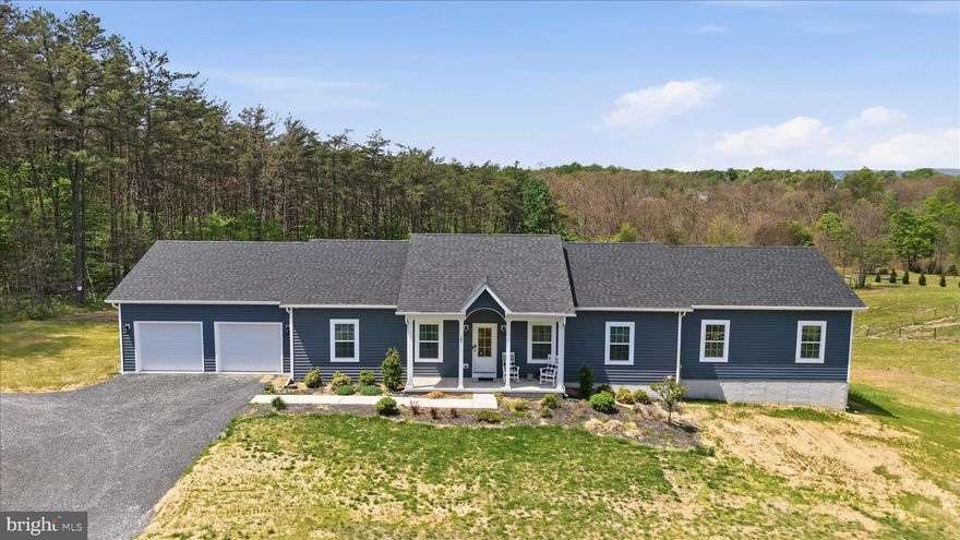 Tucked at the back of the subdivision, this 2020-built home sits on a generous two-acre lot with no HOA, where the backyard quietly gives way to a wooded tree line, a natural backdrop you'll never tire of.  Whether you're sipping coffee on the private deck at sunrise or unwinding by the fireplace on a cool evening, this home is easy to love.
The heart of the home is an open eat-in kitchen and family room with a floor to ceiling electric fireplace designed for real life — a large island anchors the space, there's room for a full eat-in dining area, and the flow to the deck makes indoor-outdoor entertaining effortless. A dedicated laundry and mudroom keeps the everyday organized right from the moment you walk in the door.
When the day is done, everyone has their own retreat. Two bedrooms and a bonus room share a well-appointed hall bath. A princess suite offers privacy with its own ensuite, ideal for guests, extended family, or someone who simply wants their own space. And then there's the primary suite: a genuine sanctuary, with a generous walk-in closet with custom built-ins, a soaking tub for unwinding, and a glass-enclosed shower that feels spa-caliber. This is the suite buyers dream about.
Downstairs, a finished home office sits within an otherwise open, unfinished walkout basement, room to grow into however fits your life. An attached shed/garage out back adds handy utility space, ideal for a ride-on mower, garden tools, or weekend projects. And because the community allows RV parking, you have the lot space to make that work without giving up your yard.
With quick access to I-81 and an easy drive down Route 45 to Winchester, the location checks every box, without sacrificing a single acre of peace and privacy.