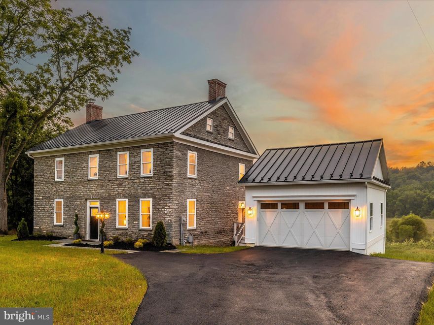 Set in a picturesque countryside, this 22-acre estate showcases a beautifully restored circa 1875 stone farmhouse that blends historical charm with modern comfort. As you enter this charming home, you are greeted by the meticulously designed main level, featuring a stunning kitchen adorned with custom cabinetry, luxurious quartz countertops, and state-of-the-art appliances - creating an inviting space for effortless entertaining. The generously sized living room boasts a grand wood-burning fireplace and flows seamlessly to the dining room and breakfast room. Every detail has been carefully considered throughout the house, from the gleaming ash hardwood floors to the deep windowsills, high ceilings, and the abundance of natural light that fills each room. Ascending to the second level, you are greeted by an elegantly appointed master suite, complete with an expansive walk-in closet and an ensuite that exceeds even the most discerning standards. The second level also boasts two additional bedrooms and a stunning full bathroom exuding timeless elegance. A thoughtfully finished attic serves as a private and luxurious guest suite retreat. Step onto the expansive back deck and be mesmerized by the breathtaking panoramic views, an idyllic setting perfect for hosting gatherings of all sizes. Beyond the charm of the farmhouse, the property features a bank barn, a shed and rolling fields, ideal for livestock and recreational activities. A new detached 2-car garage provides ample space for storage.  All new  HVAC, heating, plumbing, and electrical systems ensure comfort and peace of mind. With the addition of new windows, a new metal roof, and spray insulation, experience heightened energy efficiency and a cozy, well-insulated living environment. Conveniently located just minutes from shopping, restaurants, and commuter routes, this estate offers the perfect blend of tranquility and accessibility.