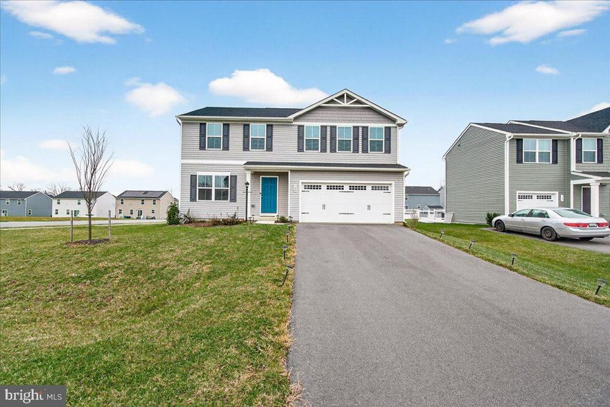 Handsome corner-lot home with stylish finishes and inviting outdoor entertaining space. The flint gray siding paired with a Georgian Bay front door creates beautiful curb appeal from the moment you arrive. Only two years young, this 4-bedroom, 2.5-bath colonial features a charming front porch that sets a warm, welcoming tone.

Inside, the bright and open kitchen shines with Frost White Quartz countertops, crisp Barnett Duraform Linen cabinetry accented by sleek black pulls, an oversized stainless-steel sink, and GE stainless appliances. A large island offers generous overhang to accommodate seating, making it the perfect spot for casual meals or conversation while cooking. The main level also includes a flexible den that can serve as a home office, playroom, or multipurpose space. Upgraded LVP flooring flows throughout the great room, providing both durability and easy maintenance.

Step from the kitchen onto a lovely patio with a built-in cooktop—an $18,000 upgrade that turns the backyard into an entertainer’s dream. The flat lot is just under a quarter acre and offers plenty of room for play or relaxation. Upstairs, four spacious bedrooms include a serene owner’s suite, while the full basement footprint (a $20,000 upgrade) with a three-piece plumbing rough-in (approximately $2,500 upgrade) provides a blank canvas to finish as you wish.

With a two-car garage, efficient construction, and the charm of a nearly new home, this property ready and waiting for its next chapter. Property is listed at the recent appraised value!