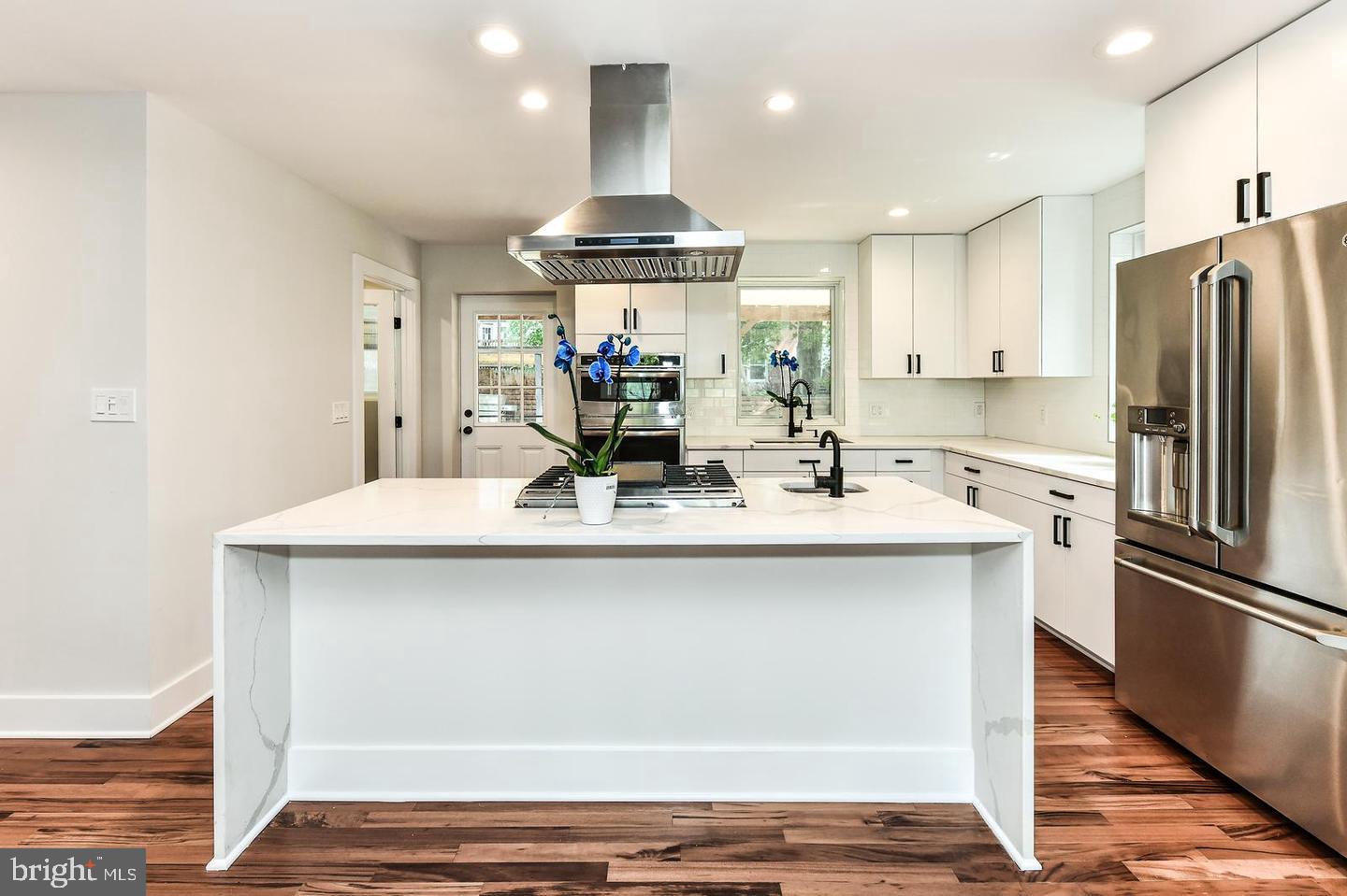 Beautiful home Prominently situated on a large lot in charming neighborhood. Full renovation (to the studs) and expansion. Gorgeous imported Brazilian Tigerwood hardwood floors throughout the main and second level. Custom full kitchen w/ a waterfall countertop, breakfast bar, and large walk-in pantry with a second refrigerator. All newer appliances with 3 ovens, perfect for the holidays and weekend entertaining. The kitchen is perfectly placed to lead out to the charming southern porch spacious enough for outdoor dining entertainment. Main level includes spacious dining room, full bathroom, large living room with a stone feature wall surrounding refreshed fireplace with feature wall lighting. Generously sized entertaining spaces, this home is ideally suited for both intimate and large gatherings. The delightful indoor living spaces are matched by the exciting outdoor spaces.