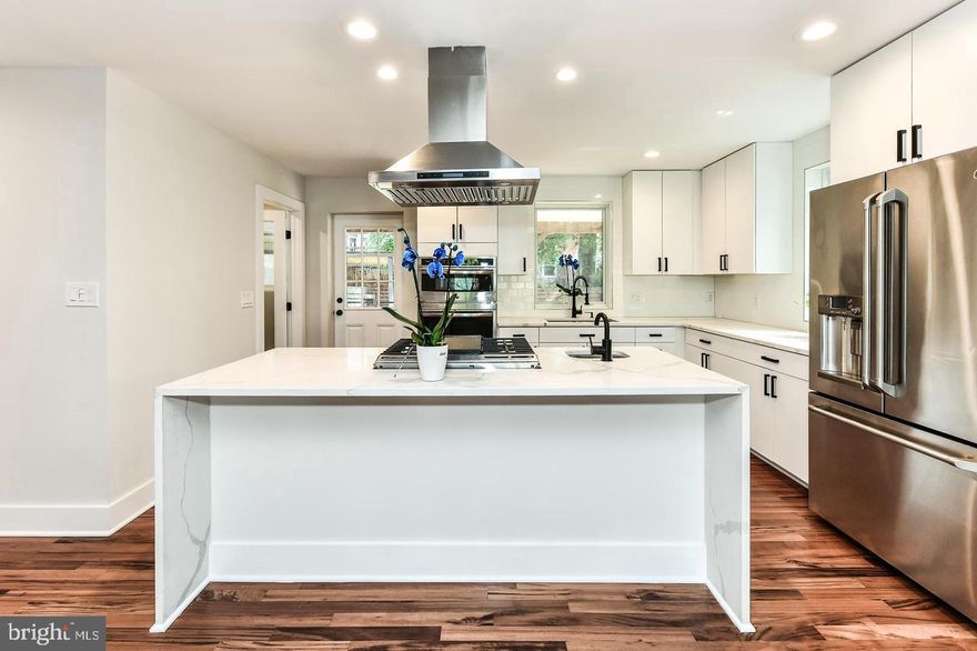 Beautiful home Prominently situated on a large lot in charming neighborhood. Full renovation (to the studs) and expansion. Gorgeous imported Brazilian Tigerwood hardwood floors throughout the main and second level. Custom full kitchen w/ a waterfall countertop, breakfast bar, and large walk-in pantry with a second refrigerator, reverse osmosis filter,All newer appliances with 3 ovens, perfect for the holidays and weekend entertaining. The kitchen is perfectly placed to lead out to the charming southern porch spacious enough for outdoor dining entertainment. Main level includes spacious dining room, full bathroom, large living room with a stone feature wall surrounding refreshed fireplace with feature wall lighting.  Generously sized entertaining spaces, this home is ideally suited for both intimate and large gatherings. The delightful indoor living spaces are matched by the exciting outdoor spaces.