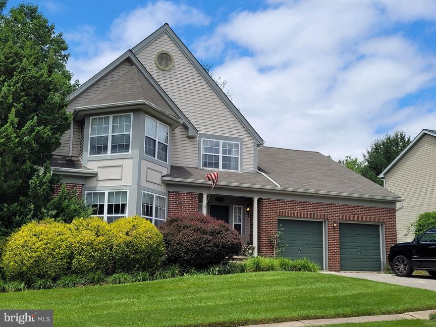 Welcome to this stately, well maintained colonial home situated on a corner lot, the largest lot in Owings Meadows. Enter from the inviting front porch to the brightly lit, freshly painted two story entry way. You'll find hardwood floors throughout the entry hall, dining room and huge family room. the front bay window brings loads of light to the stylish living room and formal dining room with a mirrored wall doubling the light. You’ll find a powder room off the hallway, just before the butler’s pantry, which boasts plenty of food storage and cabinets above and below a counter just perfect for beverage set up. Opposite the butler’s pantry is the main floor laundry with newer front load washer and gas dryer. Continue to the huge kitchen and family room. The updated Kitchen includes a stylish granite counter topped Island with SS dishwasher, sink and abundant storage. Across from the island are Maple cabinets above a granite counter with a SS refrigerator and a commercial DACOR dual fuel range with a flame broiler gas oven PLUS an electric oven, both are self-cleaning. Plus a newer microwave. Easy flow into the large family room with a fireplace (gas) a beautiful custom-built cherry wood mantel and surround with flanking custom-built cabinets and shelves along with a wall of windows for abundant natural light. Across from the butler’s pantry is a foyer that leads to the MAIN LEVEL primary suite and the 2-car garage with openers. Step into this spacious primary suite with a wall of windows that open to the custom-built deck. Making it even better, it boasts cathedral ceilings and a large walk-in closet. The primary bath also has cathedral ceilings and a large soaking tub with windows overlooking the deck. Upstairs you will find 3 large bedrooms, two of which have bump outs. all with ample closet space and a full bath. The lower level features another large family room with a gas fireplace, wet bar, and walk in closet, brightly lit with a wall of windows and sliders to the outside. There is a very large bonus room (used as a gym) with Berber carpet and French doors, built in cabinets and speakers. This level also has a full bath and storage in the under stairs closet.  Additionally, there is a large utility room with a workbench and cabinet and a spare refrigerator. WOW!!! IF THATS NOT ENOUGH, there’s an EXPANSIVE deck that faces woods for a very private feel, boasting a gazebo, which has a TV. an additional seating area and, best of all, a watering system for all the flowerpots. The landscaped .39a lot has an underground sprinkler system as well. Enjoy summer nights on your deck overlooking the lighted water fountain and gardens. NEWER roof, furnace, CAC, microwave & disposal! (The owner is open to offers on any, or all the furniture.)