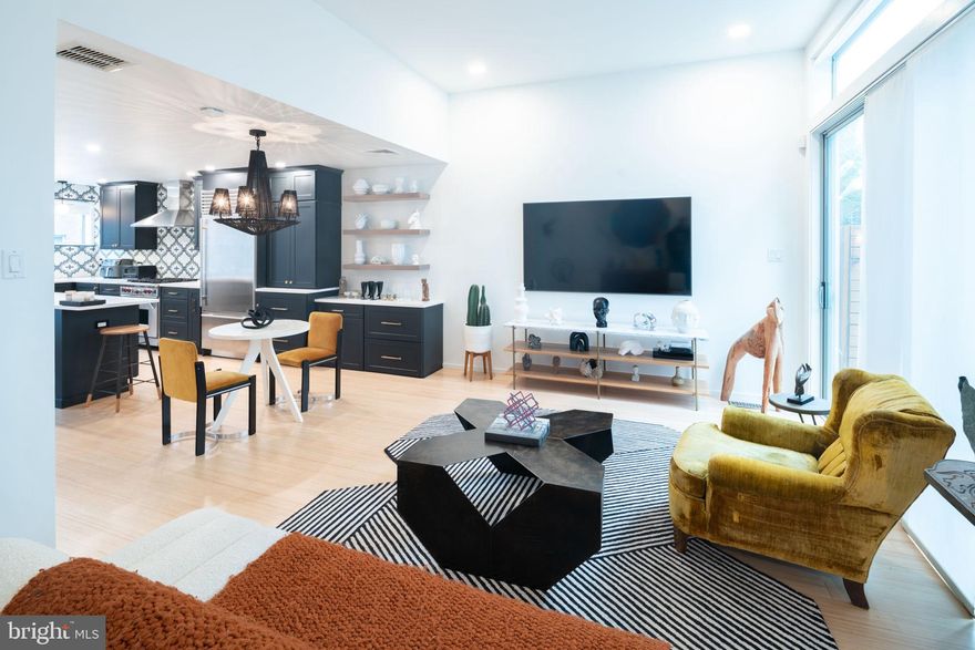 ****seller is offering one year rate buy down if buyer uses sellers preferred lender! Magnificent modern home located in Northern Liberties with Parking! Walk up to your contemporary 3-story facade home featuring Brazilian Ipe wood & flat stone panels. Through the front door, you will immediately be greeted by a light-filled, spacious main floor which graciously hosts your sitting/living room area, dining room, powder room & gourmet cook's kitchen. The 1st floor has been remodeled with refinished flooring, new lighting, a gorgeous chefs kitchen, a powder room, and fresh paint.  Tap into your inner chef in this custom-built kitchen!  With sub-zero and wolf appliances, gorgeous cabinetry, plenty of custom built-in shelving and pullouts, and a remarkable historic porcelain backsplash. Floor-to-ceiling windows and glass doors off the sitting area lead to your large private stone paved patio that is  instantly noticeable as you enter this charming home. The second floor consists of an additional living or family room with soaring ceilings, a gas fireplace with remarkable slate and floor-to-ceiling windows, a master suite with a custom-designed closet & full en-suite marble master bath with dual vanity. Continue up to the 3rd-floor which hosts 2 additional nicely sized bedrooms and another full bath with a soaking tub and standing shower. The fully finished lower level offers a washer & dryer and could serve as your own media/ movie room! Northern Liberties is one of Philadelphia's best neighborhoods for dining and drinking. Its walkable layout, top-notch bars, and authentic international eateries offer no shortage of options!