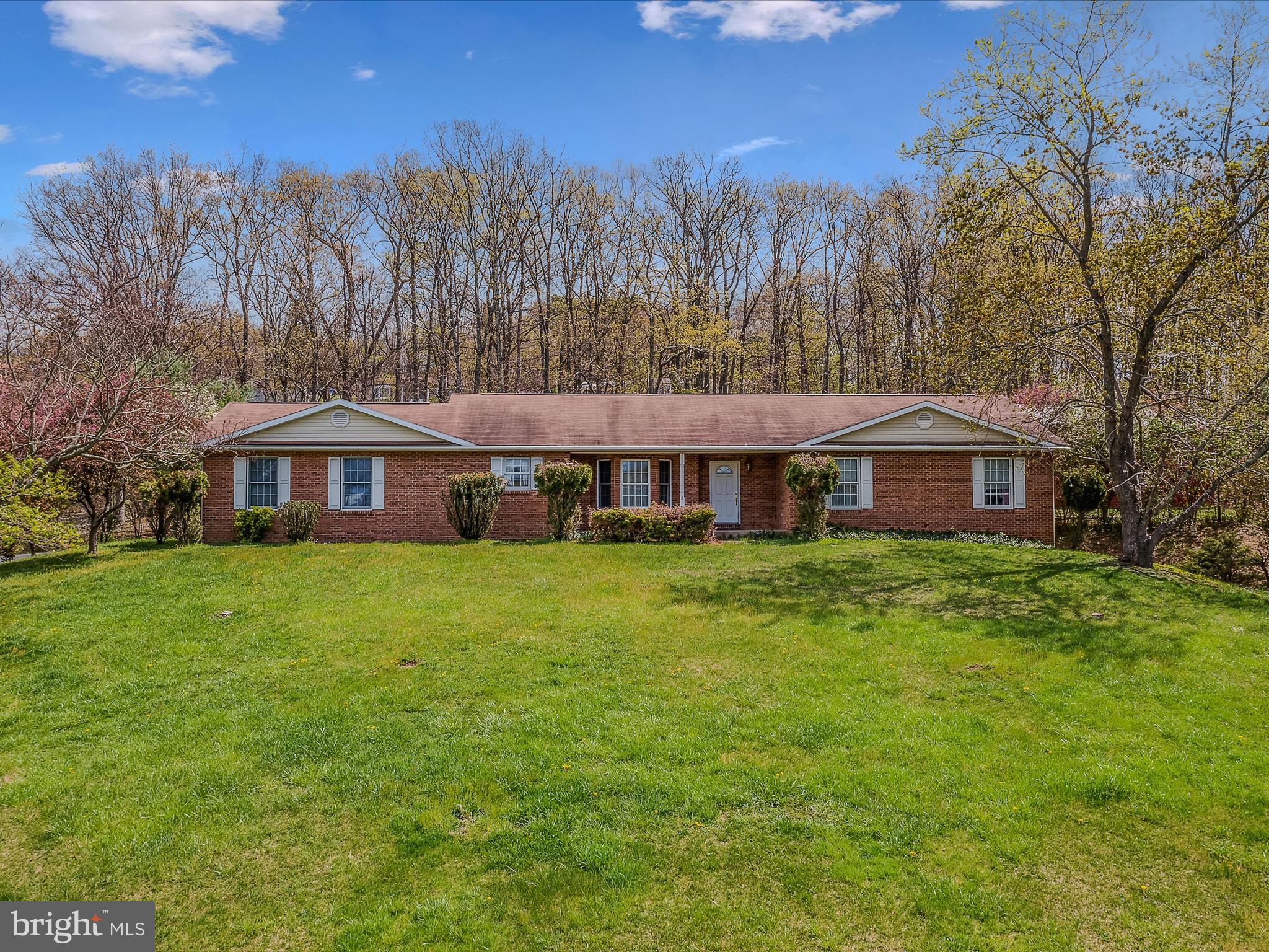 JUST REDUCED! Spacious & Gracious Custom Brick Front Home - 3 Bedrooms, 2.5 Baths, Full walk out basement has one 14.6 X 24.7 finished room. Extra wide doors and hallway make this home handicapped accessible. Flowing open floor design makes for comfortable living throughout. Main level sq. ft. 1788 w/same sq. ft on lower level. Close to downtown Berkeley Springs, Shopping and Schools parcel includes 2.65 acres, Detached 24 X 40 Garage/Storage and Detached Root Cellar. Paved driveway to your garage!