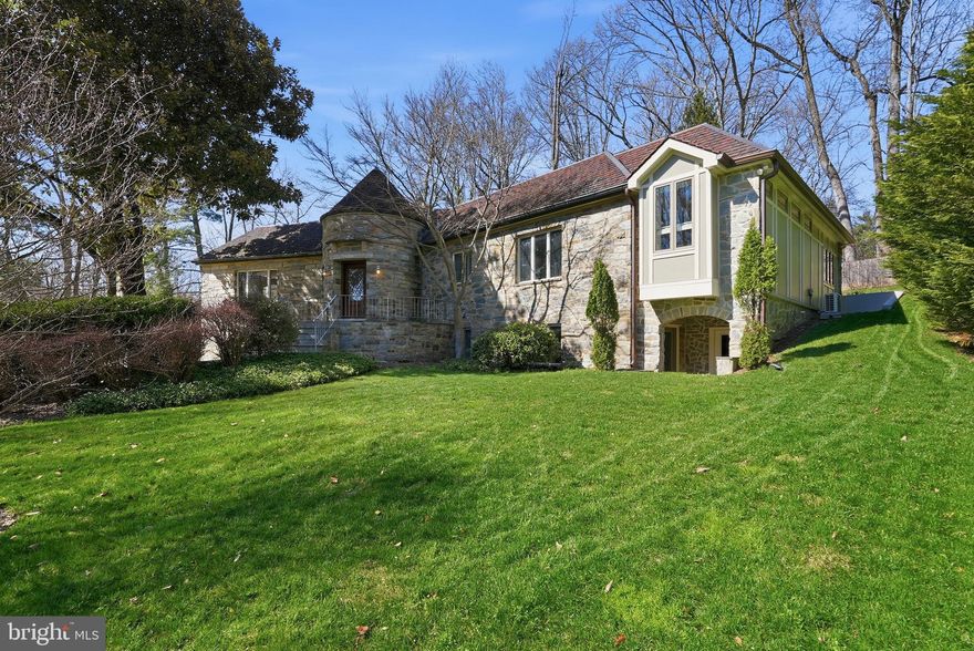 Have you been dreaming of a home that can host all of your friends while also offering a peaceful sanctuary? Welcome to 7709 Arrowood Ct where that dream becomes reality. This spacious home combines the warmth of a luxurious retreat with  extraordinary architecture and craftsmanship.  Wrapped in stone quarried from nearby Carderock Quarry, it was custom built with the quality achieved from the rare combination of cement and cinder block construction and terracotta roof.  A gracious curved foyer leads to an expansive open concept family room/dining room with fireplace, and hallway to powder room, walk-in coat closet, 3 main level bedrooms, 2 renovated baths and private office.  A recent two-story addition offers a sun filled, open. concept chef’s kitchen with vaulted ceiling, two islands, two dishwashers, extensive cabinetry, and breakfast area open to a 2nd family room as well as an elevator to the lower level and garage.  A second recent addition expanded the primary bedroom, added an expansive walk-in closet, office/sitting room, renovated primary bath and 2nd washer/dryer.  Both additions were wonderfully executed by Kader Construction.  The lower level boasts a foyer/mudroom entry off of the garage, elevator, recreation room, 4th bedroom with en-suite bath, 2nd laundry room and 3 storage spaces. The backyard allows you to appreciate all that this approx .5 acre lot has to offer. You’ll find entertainment space with a large deck, recently built outdoor kitchen, stone waterfall, fish pond and plenty of yard area. Major system highlights include generator, elevator, 3 zone HVAC, 2 laundry areas and multiple storage options. Close to shopping, dining and top rated schools with easy access to DC and VA. Don’t miss this special home!