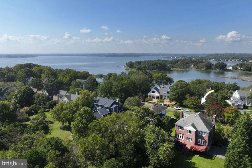 3419 Hidden River View Road is modeled after the ante bellum Natchez, Mississippi estate home “Rosalie.” It is framed by its lush landscaping and offers limited water views of Cherry Tree Cove. The property showcases the timeless elegance of the classic Greek Revival architecture, with its balanced and symmetrical design and two-story portico. The deep front porch is a serene place to sit and is a welcoming approach for visitors. The entryway sets a tone of grandeur with a two-story ceiling and an impressive staircase. 10 ft ceilings continue throughout both floors, adding to the home's airy and expansive feel. The location is perfect and provides easy access to the Fishing Creek Farm community clubhouse, pool, boat ramp and marina.

The floorplan on the main level has a wonderful flow, with a kitchen and adjoining breakfast room overlooking the back yard. A spacious main level deck, ideal for grilling and entertaining, is accessible from both the dining room and breakfast room. The living spaces feel private while maintaining a sense of openness. A cozy den, facing the living room, will be your winter hang-out with room for bookcases and comfortable seating flanking the propane fireplace. Upstairs, a sunny space overlooking the back yard is the perfect home office or reading nook. Two large bedrooms share a bathroom, and one has direct access to the upstairs porch. The primary suite has its own access to the front porch and a beautiful ensuite bathroom and walk-in closet. The fully finished, walk-out lower level has a huge rec room and a bedroom with full bathroom. The oversized garage enters this level.

Residents love living in Fishing Creek Farm – there are so many resort amenities, yet you are minutes into Annapolis or to major commute routes. If boating isn’t the plan for the day, bike-ride to the tennis court or enjoy a game of pickle ball. In the summer months, it’s nice to have someone else taking care of the swimming pool. This property would welcome an avid gardener or some playful pets with the large yard. The original owner built the home with pride, and it shows in the construction details such as thick crown molding and the hardwood floors.