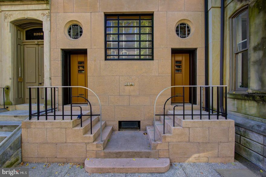 This stunning Fitler Square mansion, once the Sunderland Residence, was masterfully designed by renowned architect Harry Sternfeld, known for his work on The Architect’s Building (now the Kimpton Hotel Palomar) and other highly regarded projects such as the US Courthouse and Post Office at 9th & Market Streets. The Art Deco facade is a standout feature,with machine age milled aluminum stair fittings and lighting adding a unique touch leading to an almost magical interior filled with ethereal light and spaces with great proportions. The Moorish arched entry hall is just the beginning of a storybook journey, with lushly layered wood paneling and a 16th century Milanese stone fire surround in the library. The front parlor is museum-like., The Great room on the second floor spans the entire width of the home, featuring impressive Dynalab steel cabinetry in the kitchen, which opens to the combination living and dining area. The main bedroom on the third floor boasts an en suite terrazzo-floored period bath, while laundry and generously sized bedroom with en suite bath complete the floor. The fourth floor has another large bedroom, tile bath and an expansive den that opens to the south-facing roof deck. The brick paved lush rear patio on the ground level and separate one bedroom, one bath guest/au pair apartment in the rear of the 1st floor and garden level offer additional space and flexibility. The separate entrance to the guest/au pair apartment could also be used for a professional office, making this an excellent work-from-home location. The basement offers additional storage, a gym, and mechanicals. Close to 30th Street Amtrak, 676, 76, and PHL Airport, as well as all the shopping, dining, arts, and culture that make Philadelphia a world-class attraction, this Fitler Square mansion is the epitome of timeless beauty and elegance.