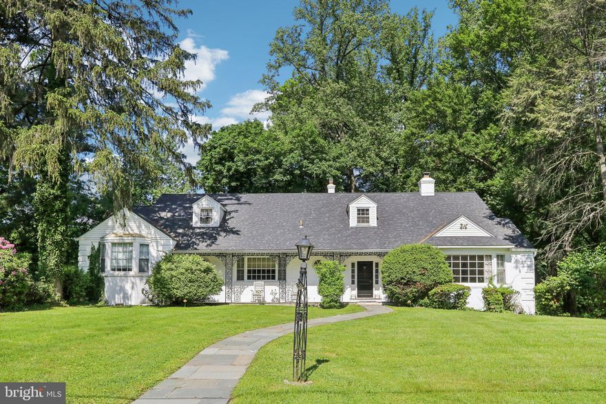 Nestled on a spacious lot along one of the most peaceful and picturesque streets in Elkins Park, this stunning home offers a perfect blend of charm and modern convenience. The welcoming foyer features brand-new flooring, setting the stage for the rest of the home. The freshly painted interior enhances the bright and airy feel throughout. The sunlit living room features a striking marble wood-burning fireplace and gleaming hardwood floors, creating a warm and inviting atmosphere. The formal dining room, accented with elegant French doors, opens onto an expansive flagstone patio—ideal for outdoor gatherings. The well-appointed eat-in kitchen boasts brand-new stainless steel appliances, luxurious granite countertops, a dining area, and a breakfast bar for casual meals. The main level provides plenty of space to relax, including a cozy den or office with a custom built-in wall unit and a large picture window framing scenic views. The Primary Suite includes a private dressing area and a new ensuite bathroom, offering a serene retreat. Two additional bedrooms, with a convenient Jack-and-Jill style full bathroom, complete the main floor. Upstairs, you’ll find two additional generously-sized bedrooms and two additional ceramic tile bathrooms. Storage is abundant throughout the home, including a walk-in cedar closet on the upper floor as well as a large attic storage area. The finished basement is designed for versatility, serving as a recreation room or additional living space complete with a bar, a convenient half bath, and a dedicated laundry area with direct access to the two-car garage. The serene, tree-lined backyard is a private oasis, filled with lush greenery, perfect for enjoying nature or entertaining guests. Additional updates include new HVAC (2024) and roof replacement in 2019. This remarkable home seamlessly blends character, comfort, and functionality in a highly desirable location close to parks, public transit and all that this sought-after area has to offer.