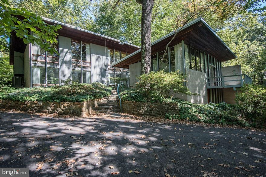 This one-of-a-kind contemporary sited high on a wooded lot is now available for rent.  A treehouse effect is created by massive windows in every room, overlooking peaceful views in all directions.  The main level provides an atrium entrance hall, sunken great room with fireplace, master suite with bath, dining room, family room, powder room, floating staircase, and access to a glass roofed breakfast room.  The upper level has a second master suite, two guest bedrooms, a built-in desk, and a full bath.  The lower level provides a nice in-law/au-pair with a private entrance family room, bedroom, full bath, and storage.